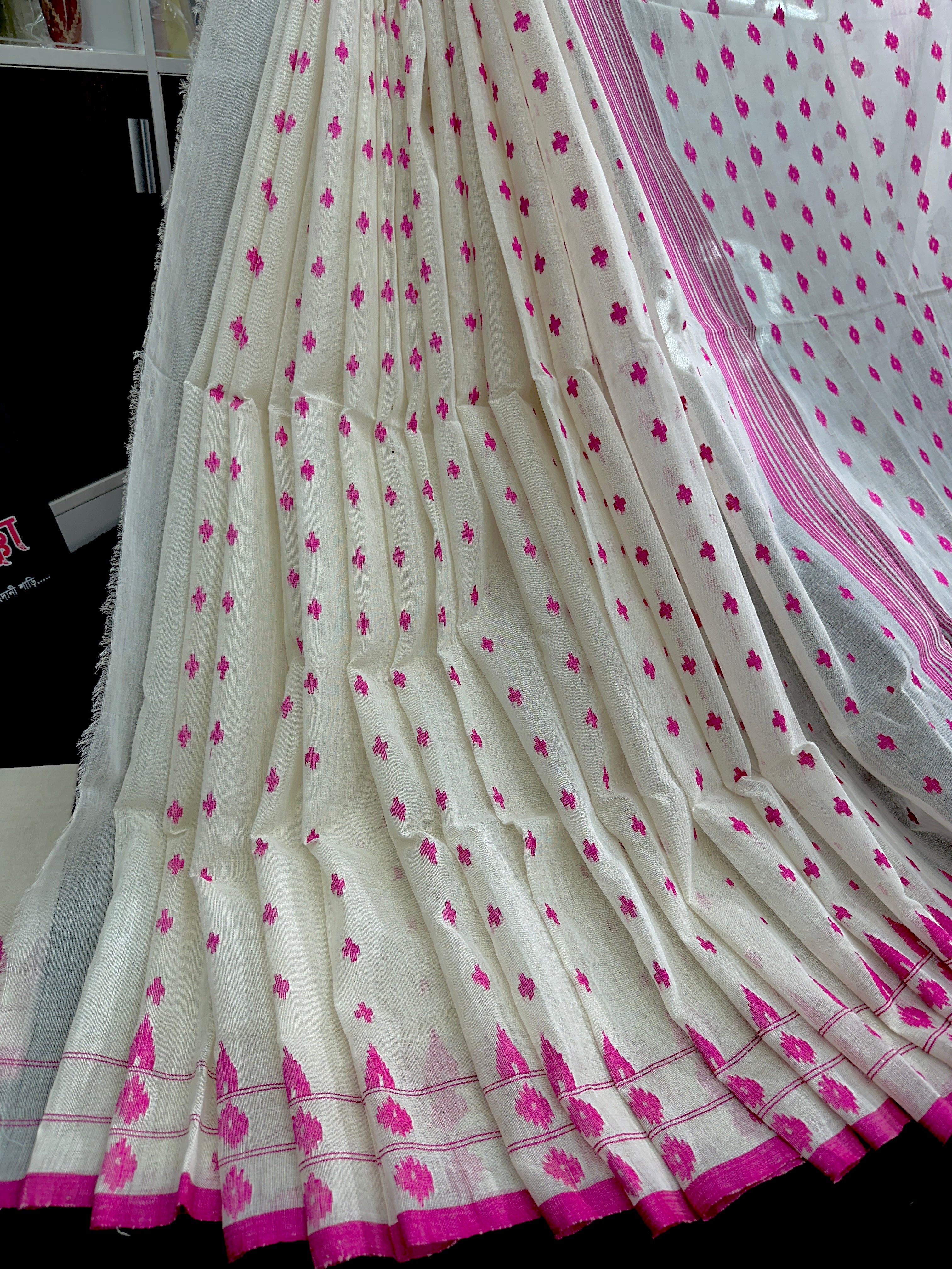 White cotton jamdani saree with pink buta and pink threads work