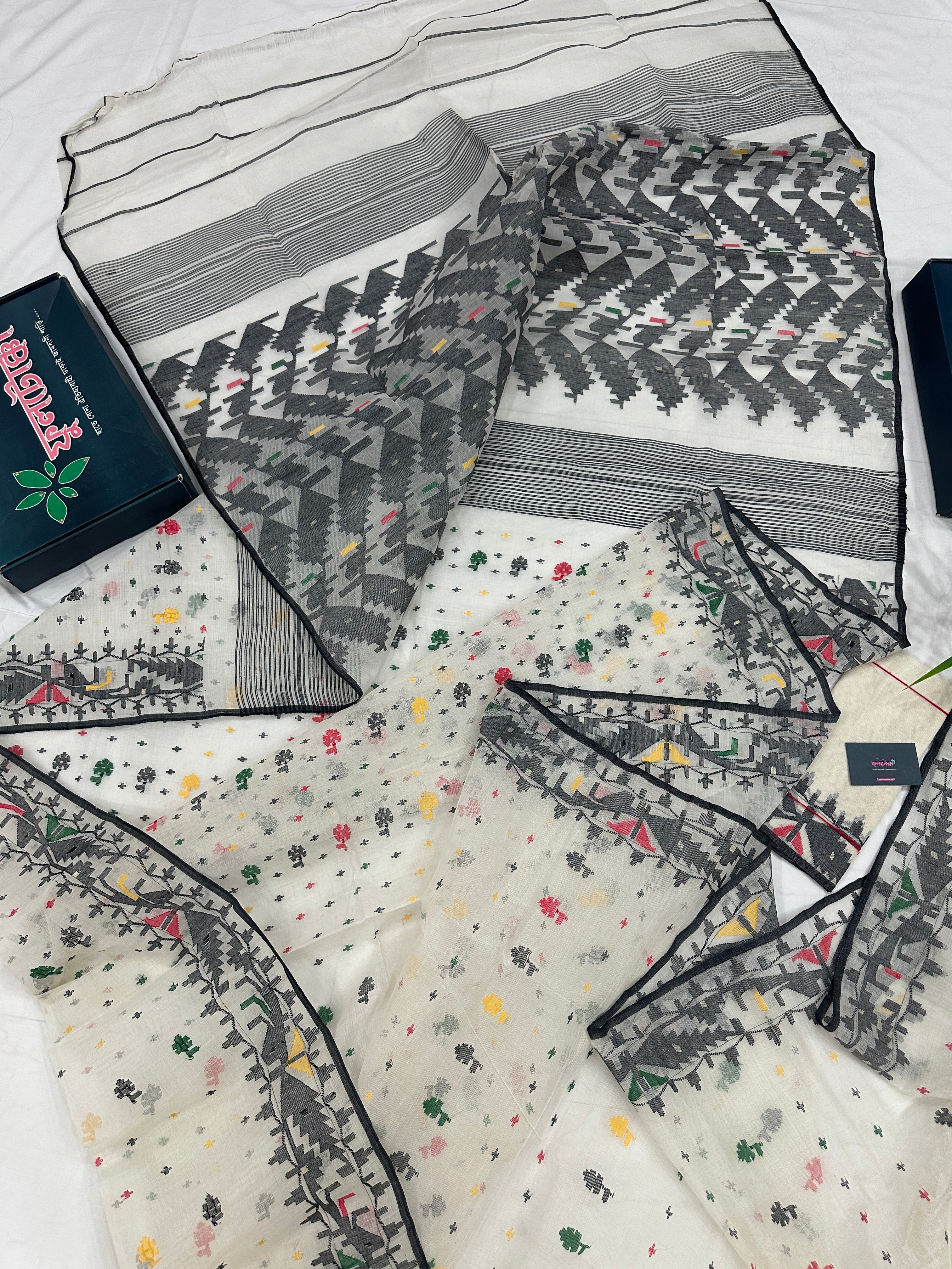 White cotton jamdani saree with black red yellow green threads work & blouse piece.