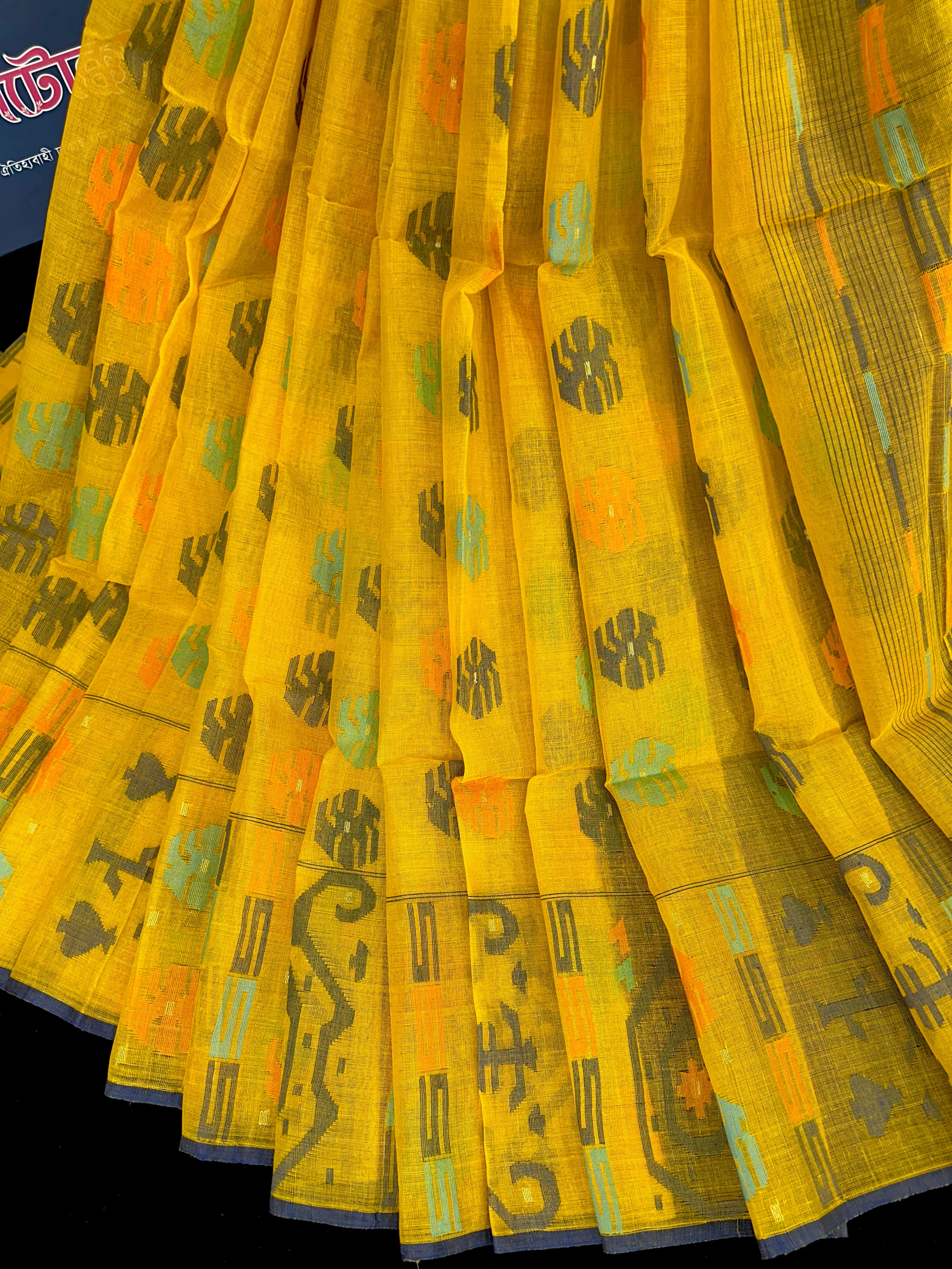 Yellow cotton jamdani saree with orange grey green blue colour threads work.