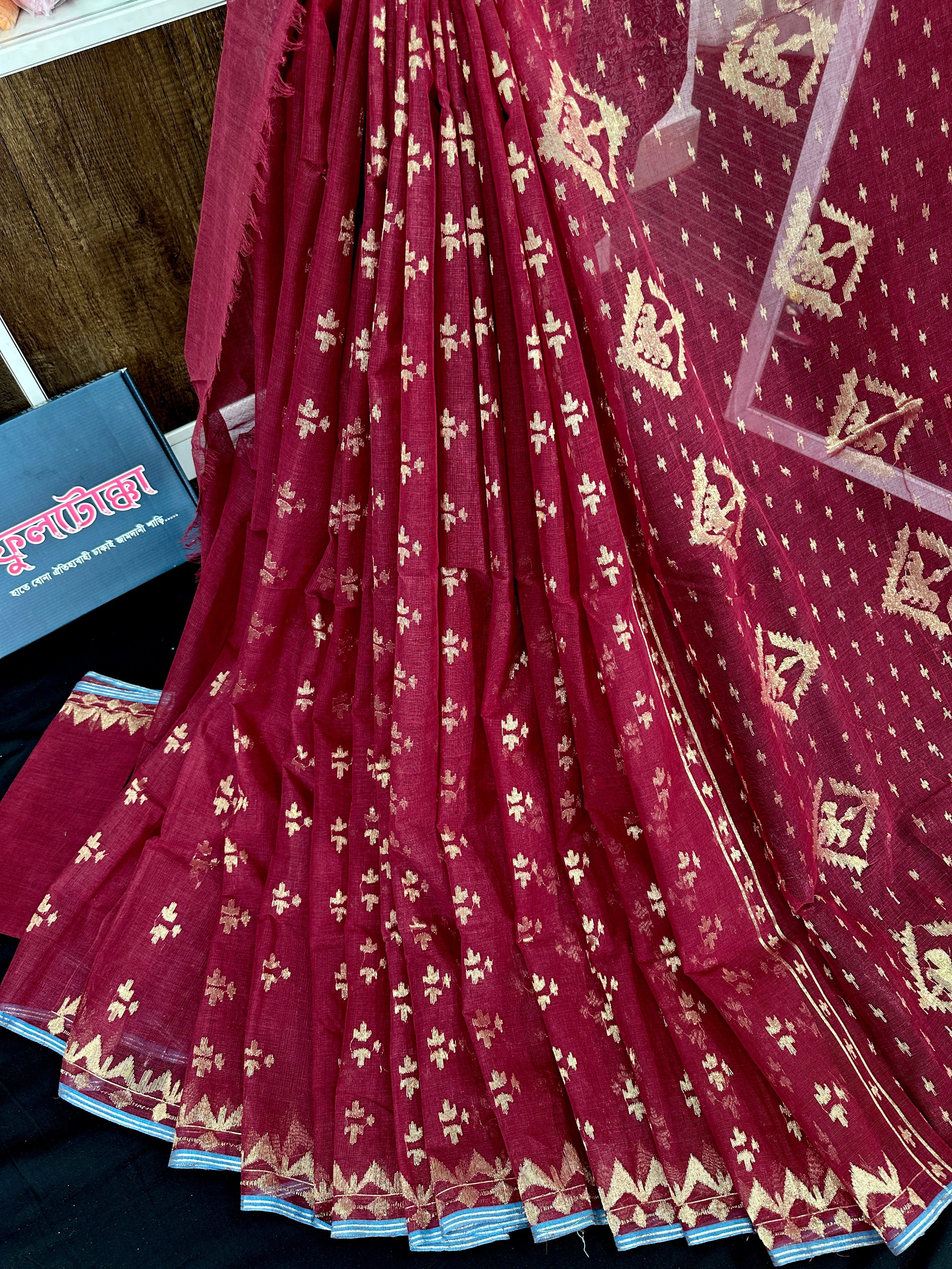 Maroon cotton jamdani saree with golden jori work and blouse piece.