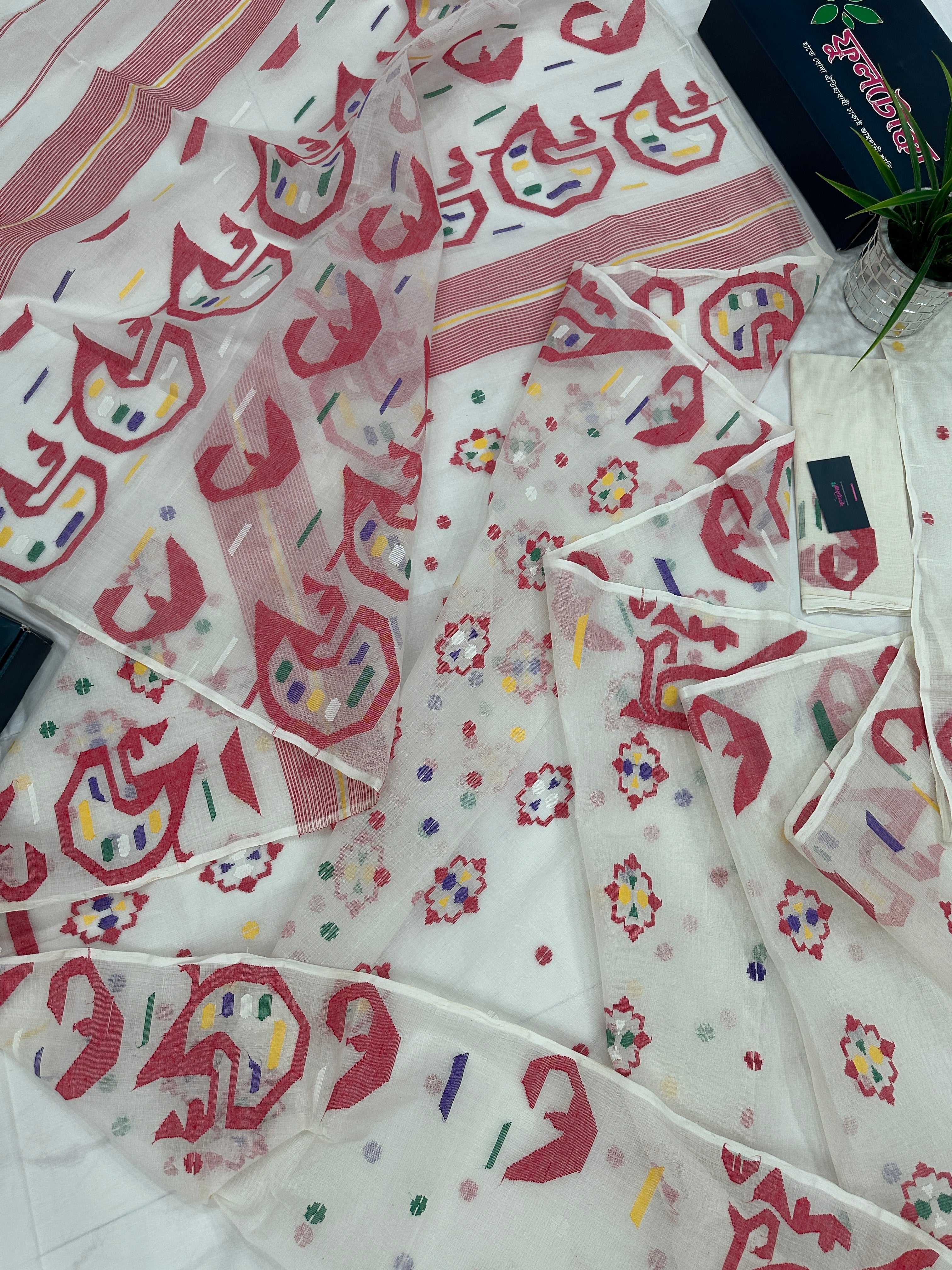 White cotton jamdani saree with multiple colour threads work and blouse piece.