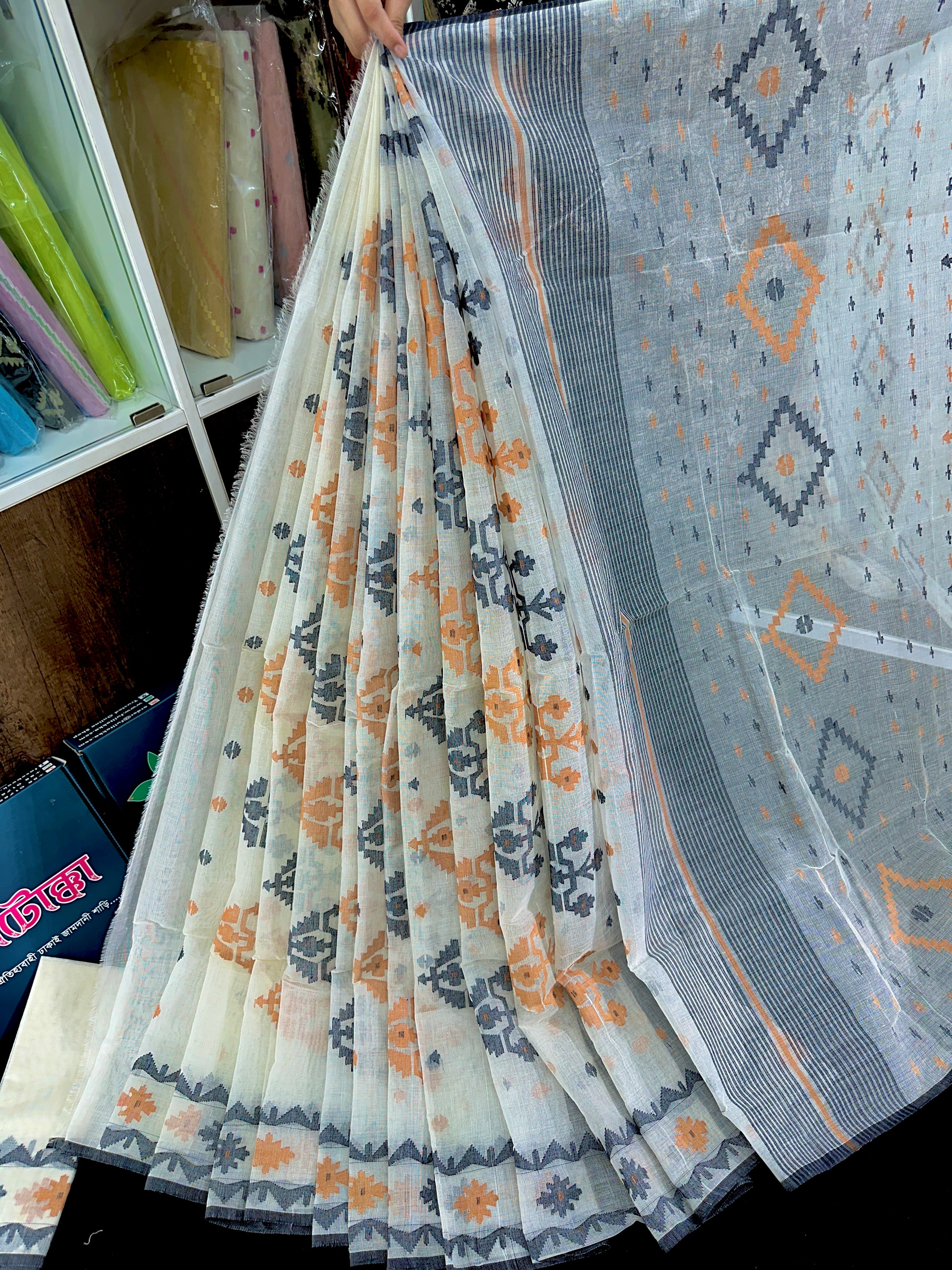 White cotton jamdani saree with orange black floral threads work