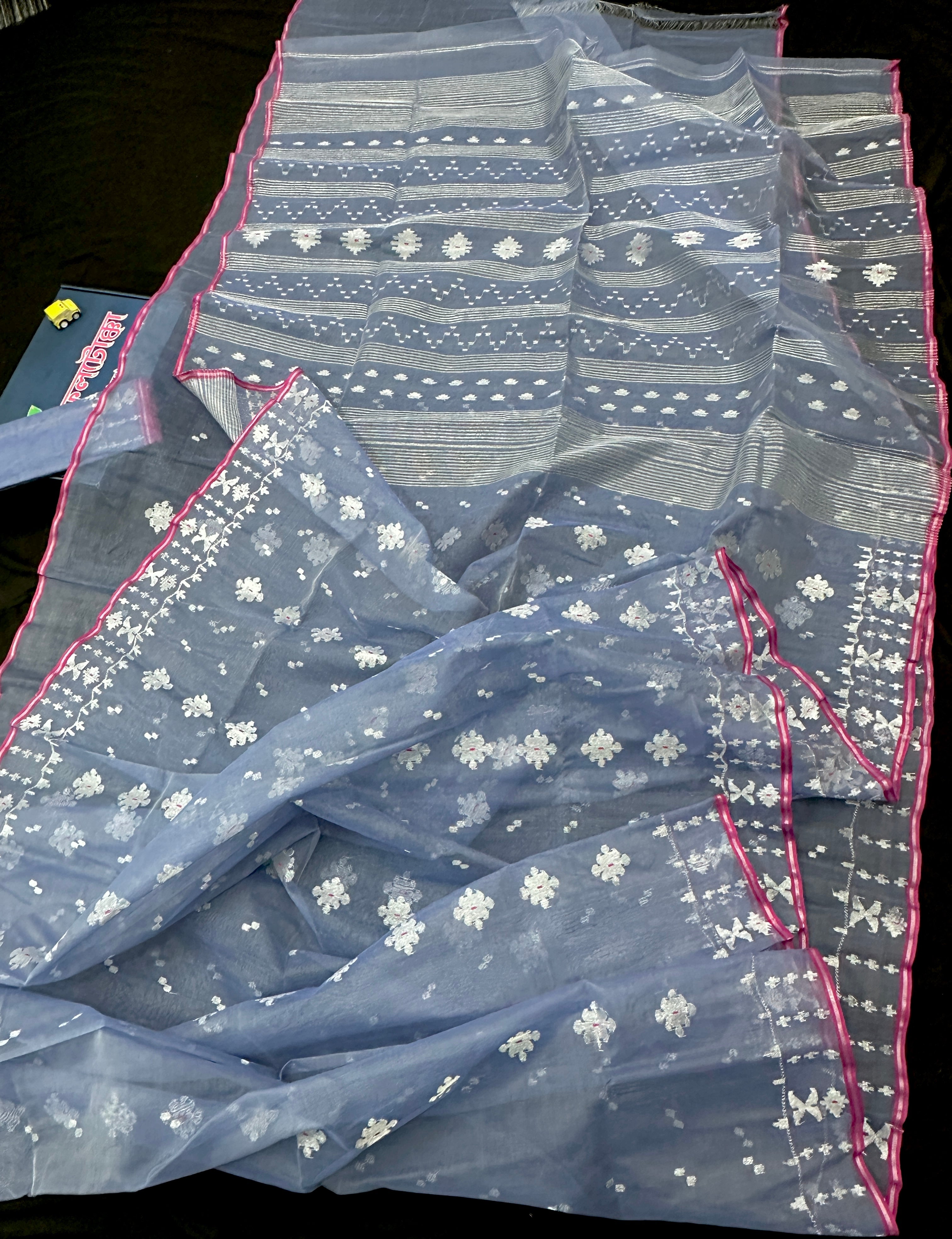 Ash blue Dhakai Jamdani features intricate silver jori work.