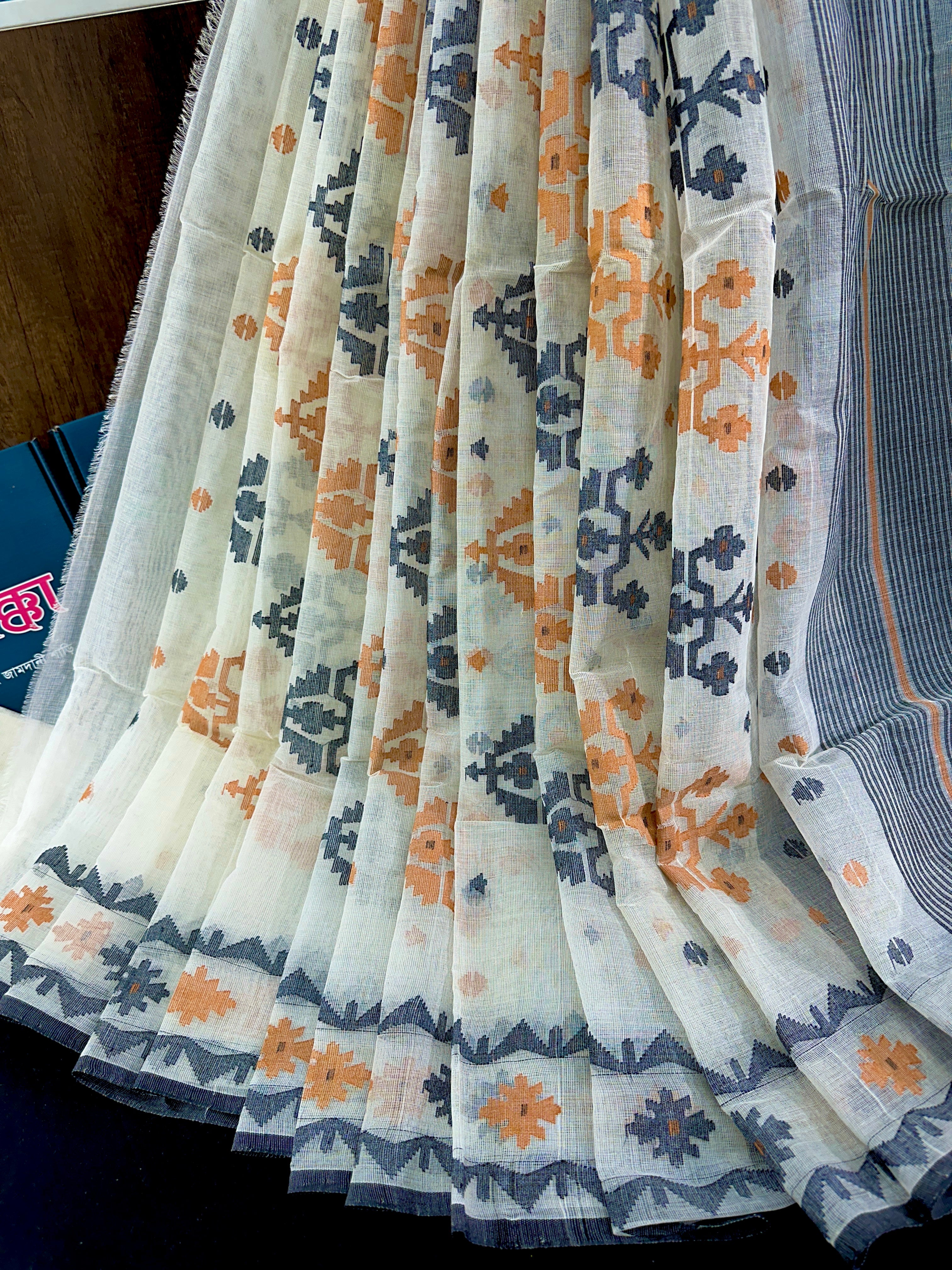 White cotton jamdani saree with orange black floral threads work