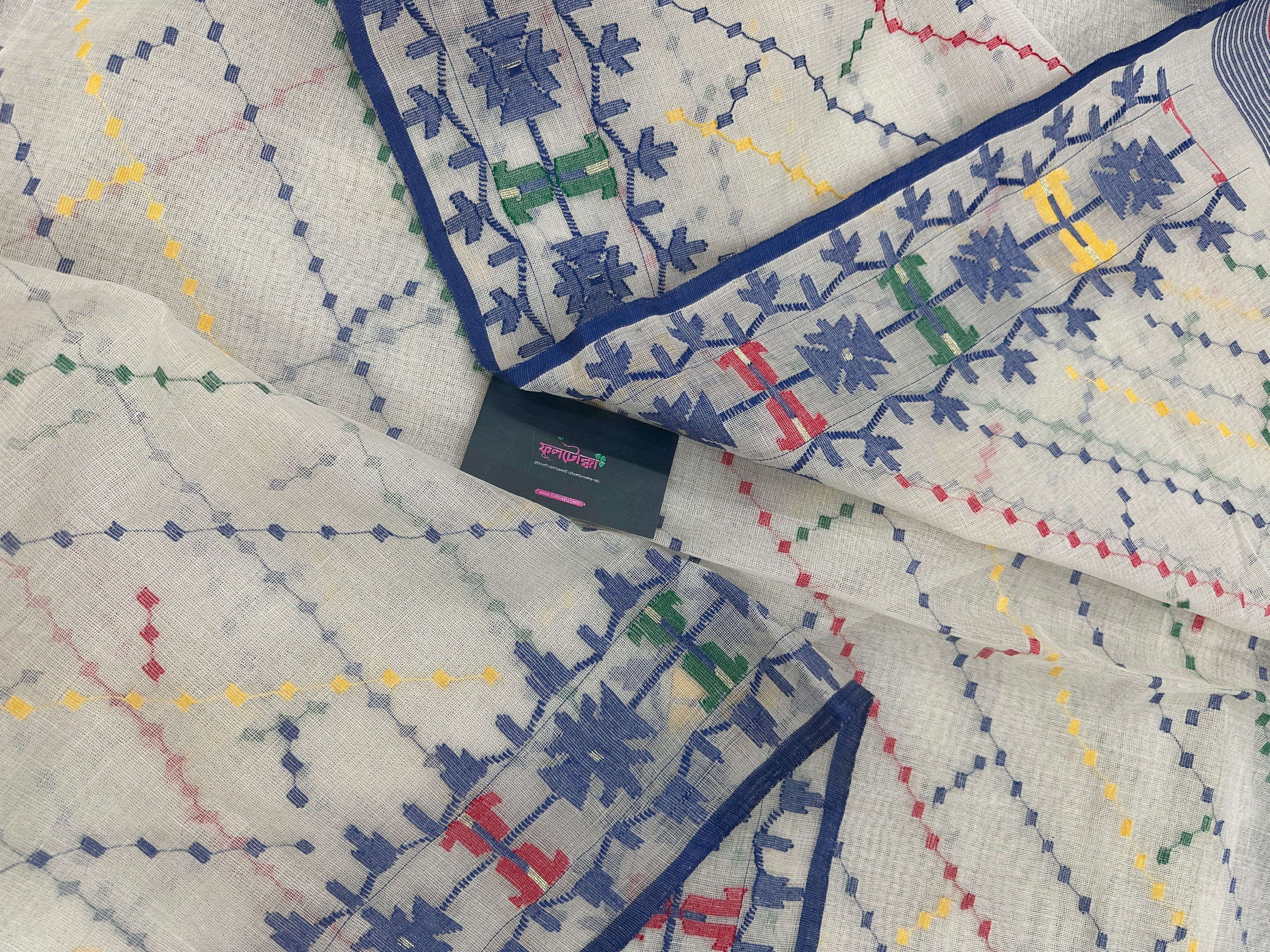 White cotton jamdani saree with blue yellow red green threads work& blouse piece.