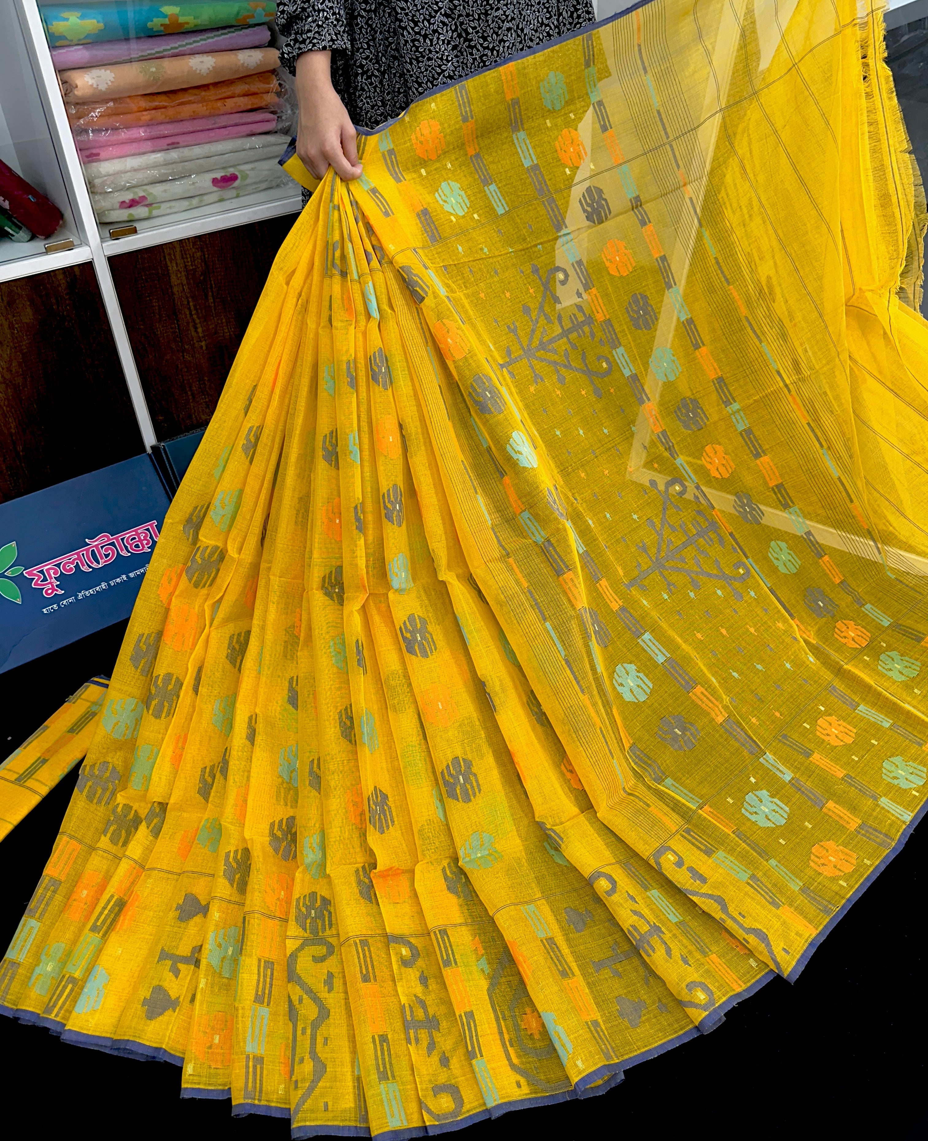 Yellow cotton jamdani saree with orange grey green blue colour threads work.