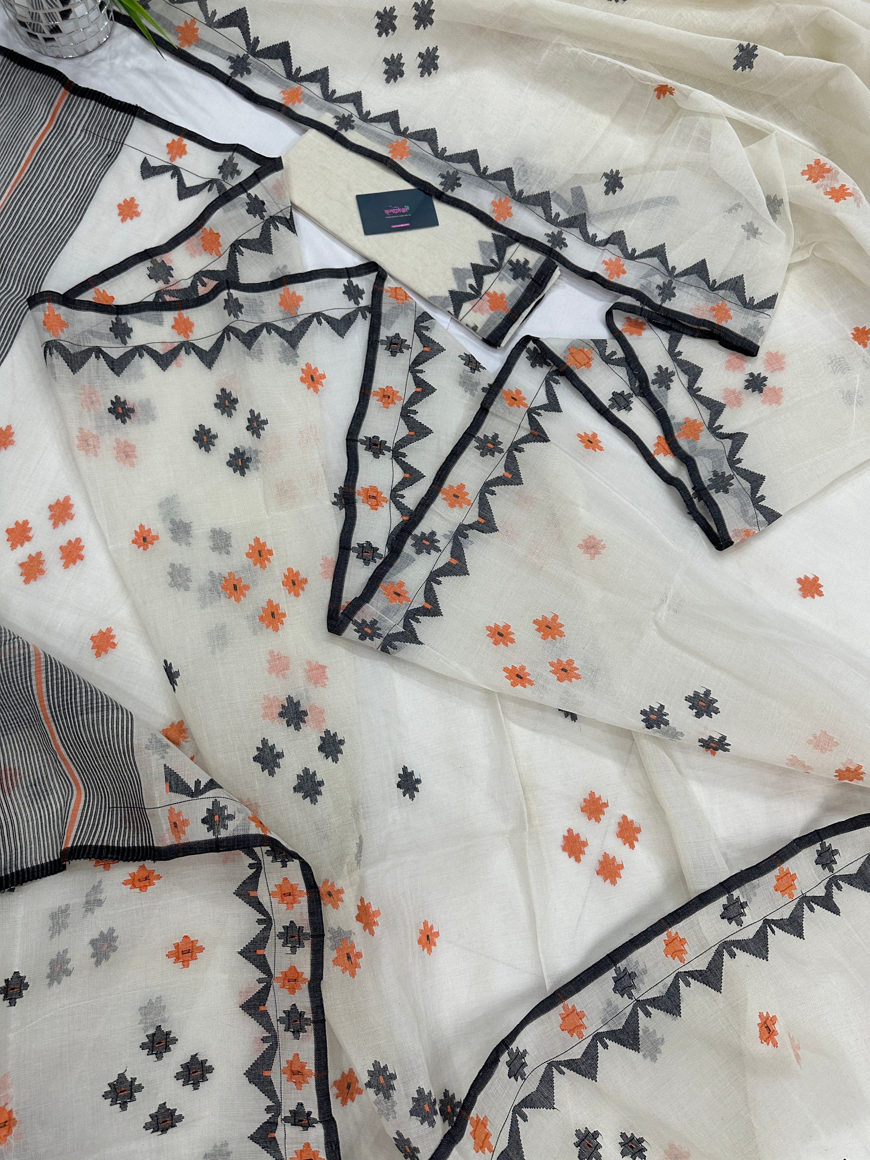 White cotton jamdani saree with orange & black threads work.