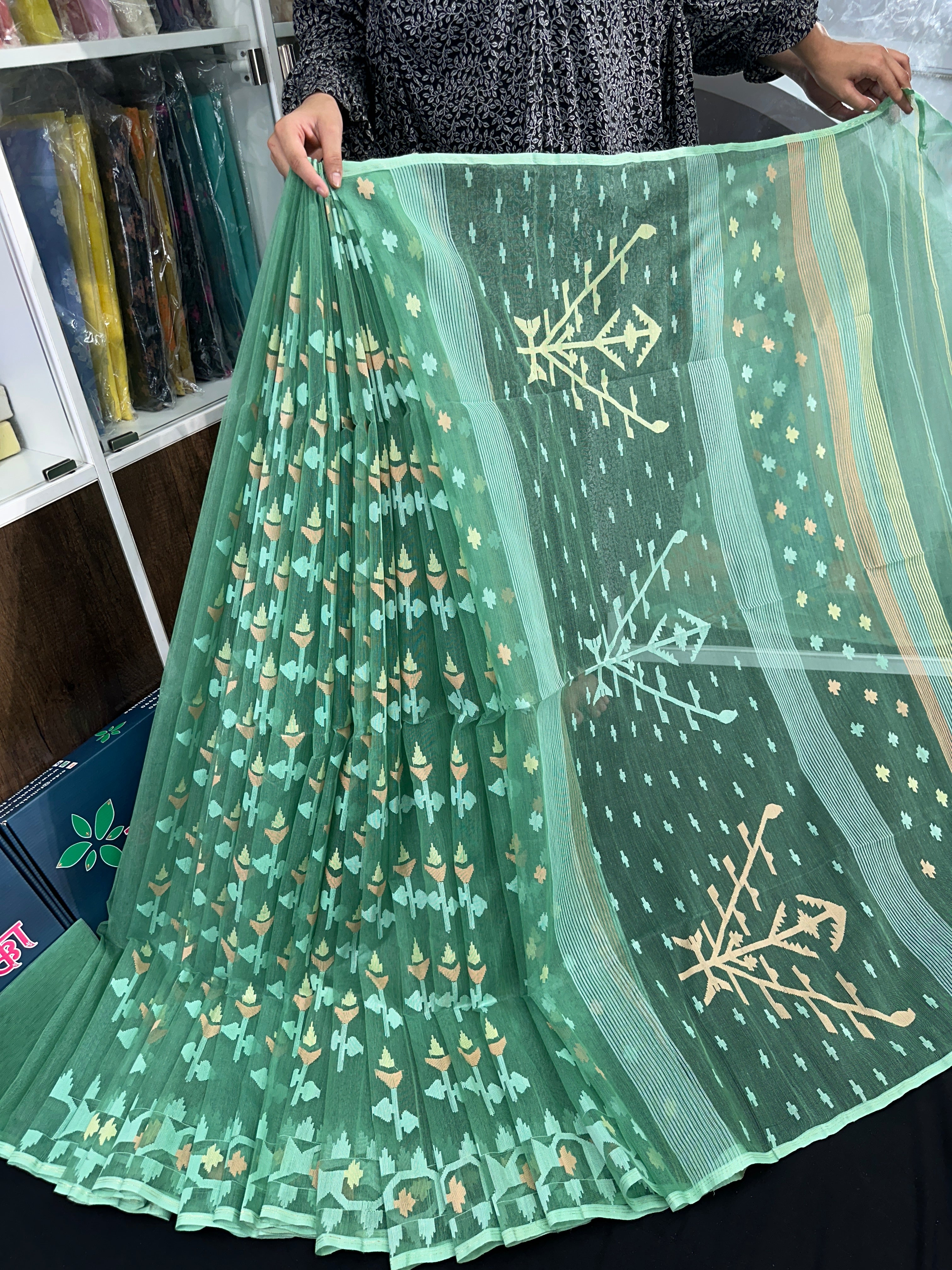 Jade green halfsilk jamdani saree with green off white golden self threads work