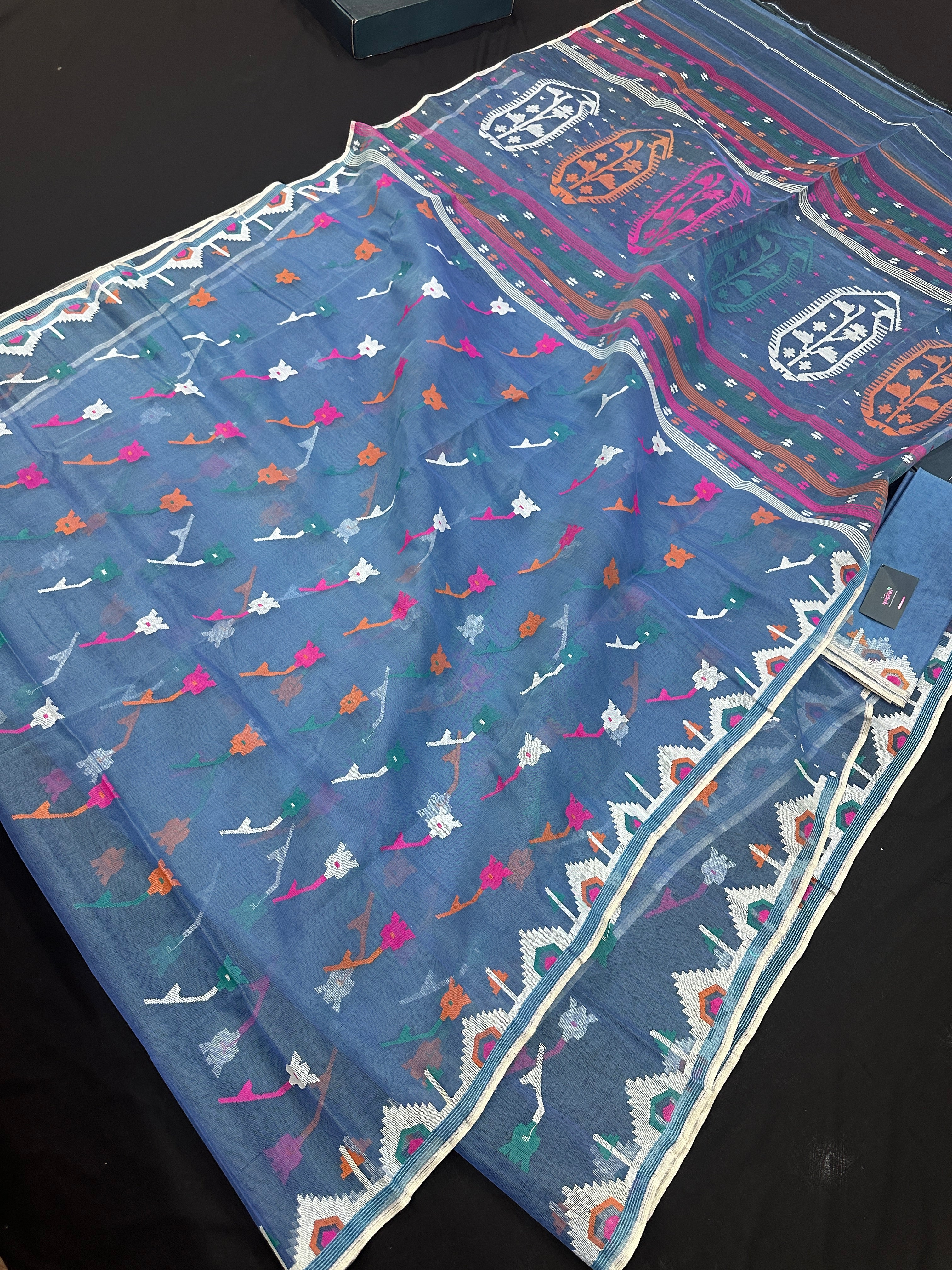 Dusty blue jamdani saree with pink white blue green work and white paar.