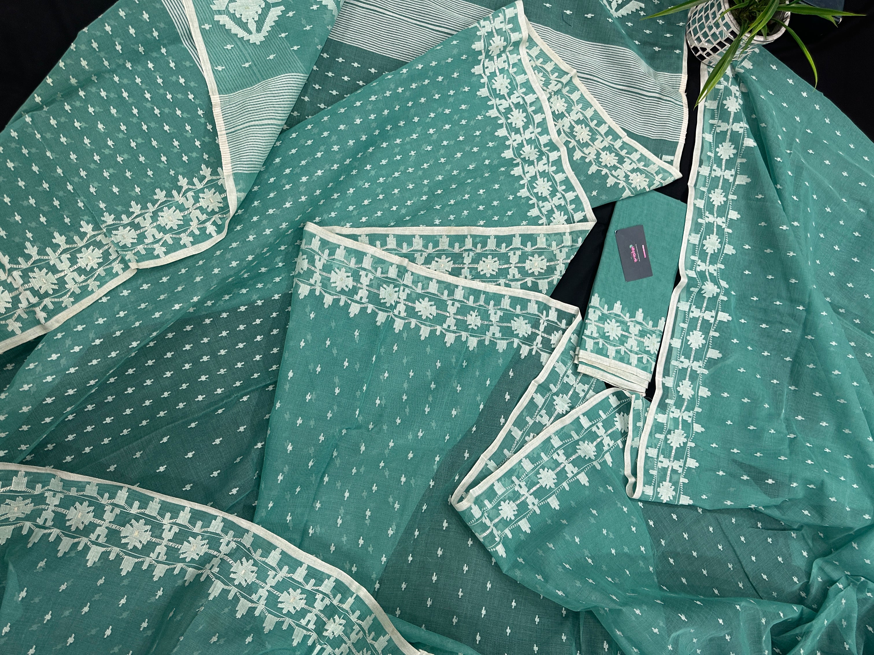 Mint cotton jamdani saree with white threads work all over work and blouse piece.