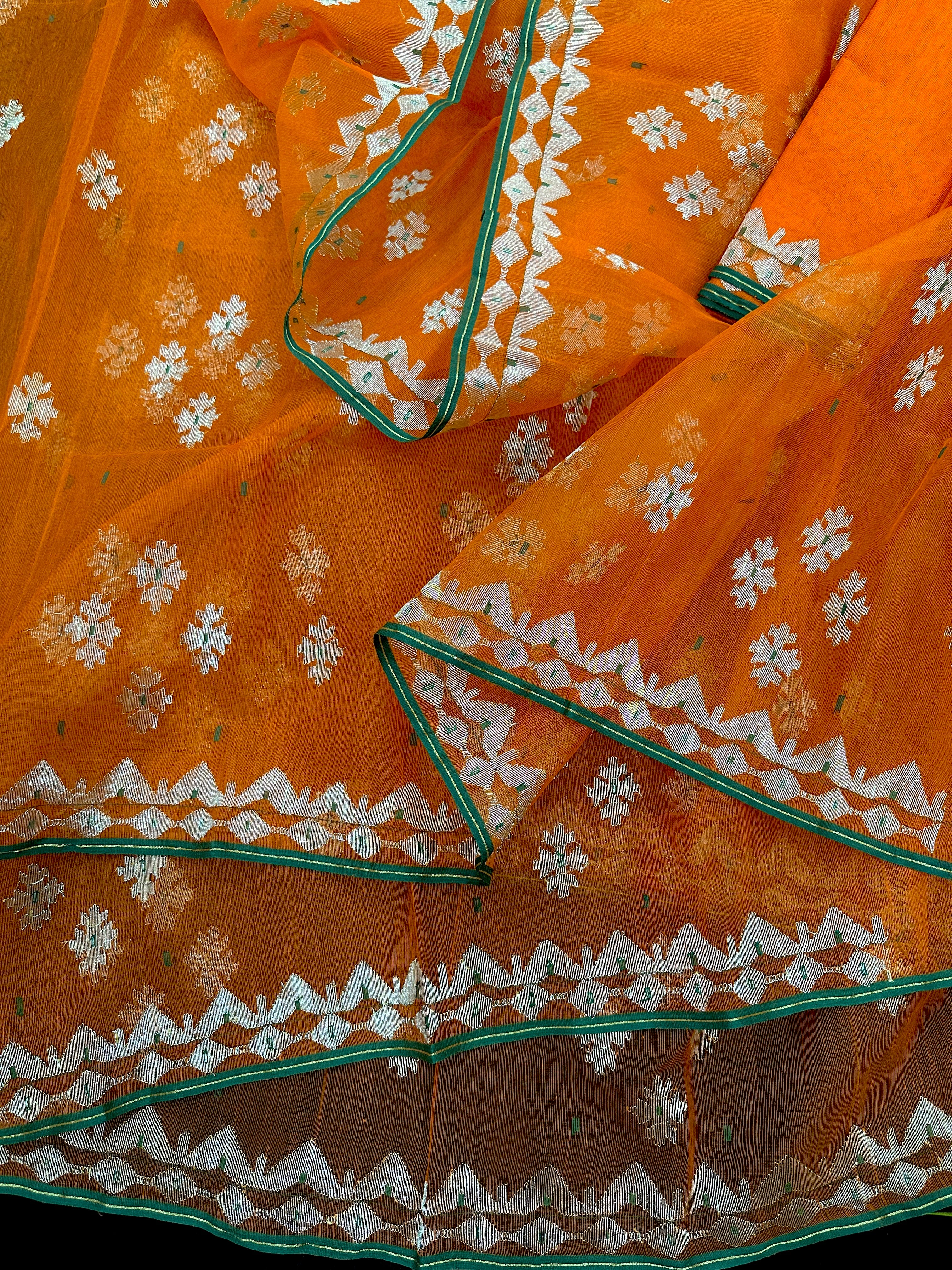 Orange soft jamdani saree with silver jori work & green border.