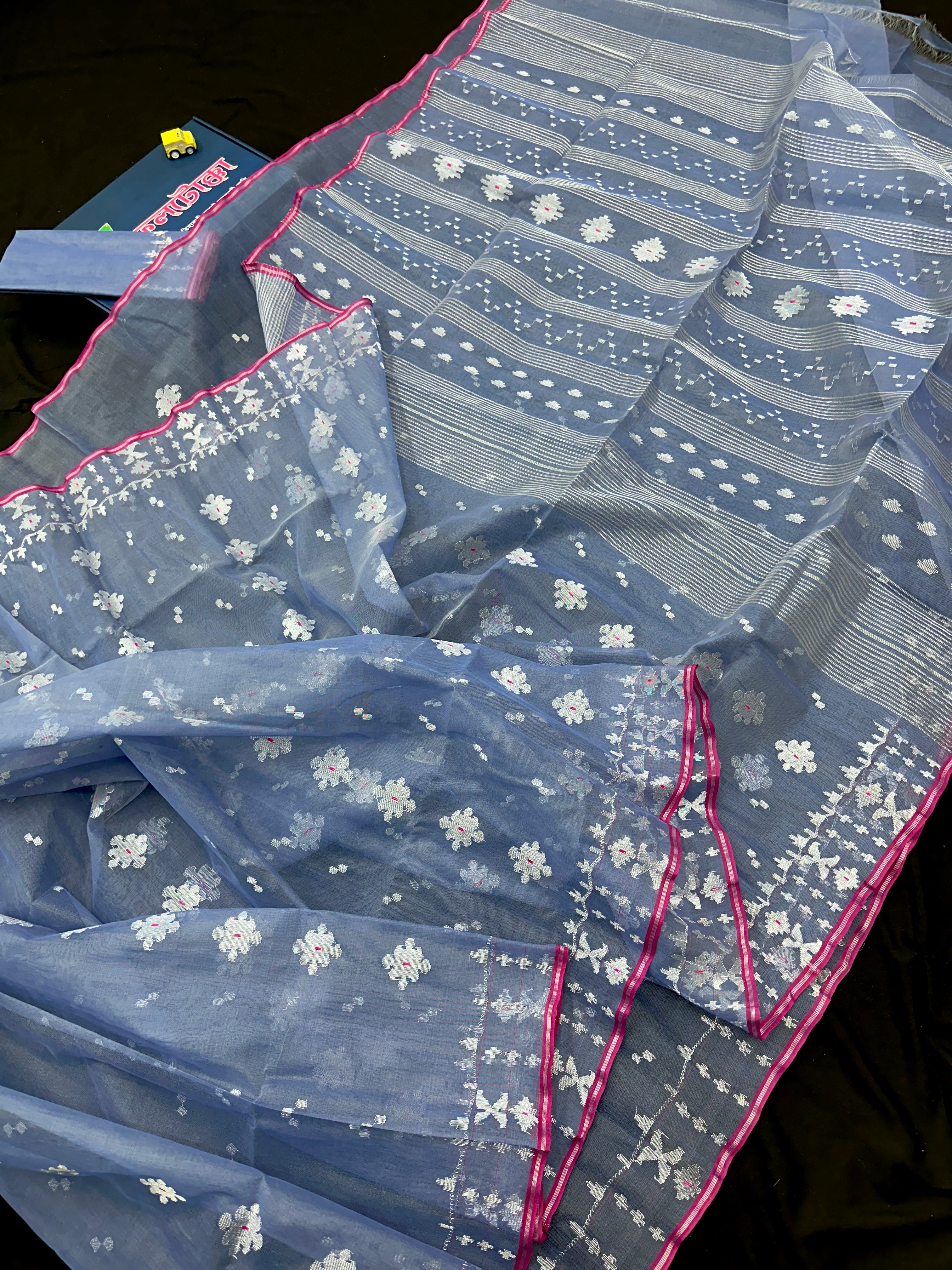 Ash blue Dhakai Jamdani features intricate silver jori work.