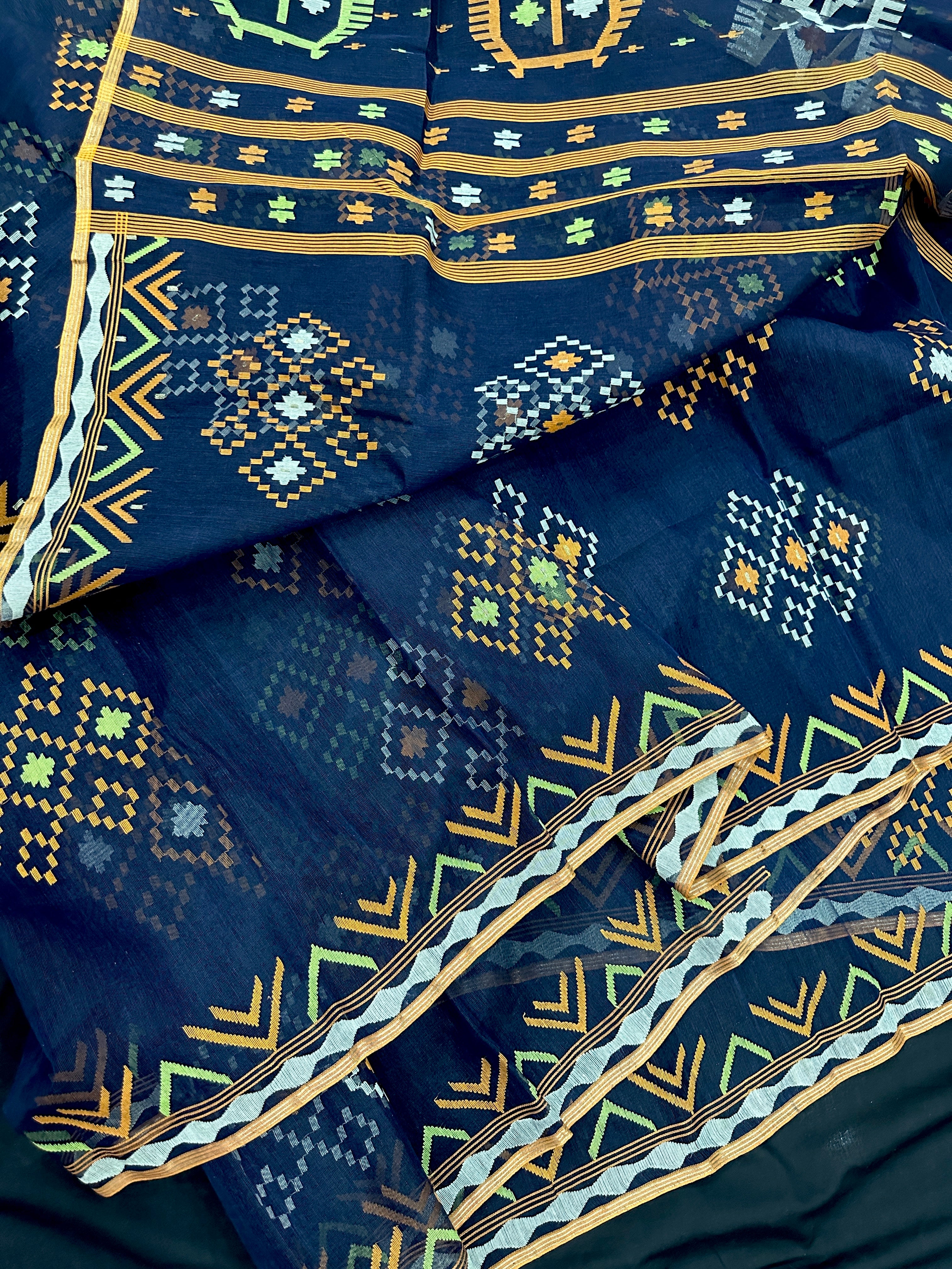 Navy blue jamdani saree with orange  green & off white threads work.