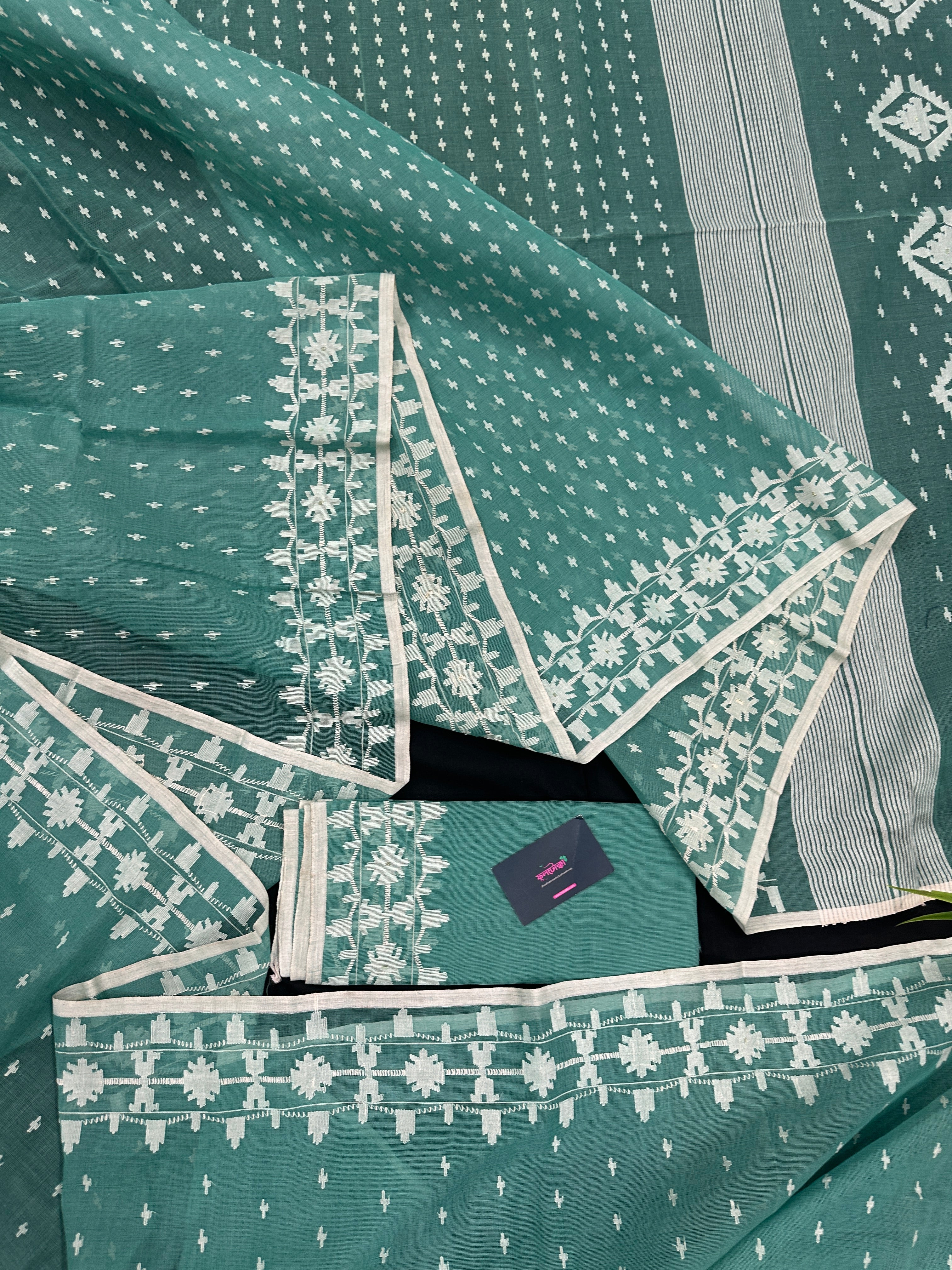 Mint cotton jamdani saree with white threads work all over work and blouse piece.