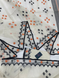 White cotton jamdani saree with orange & black threads work.