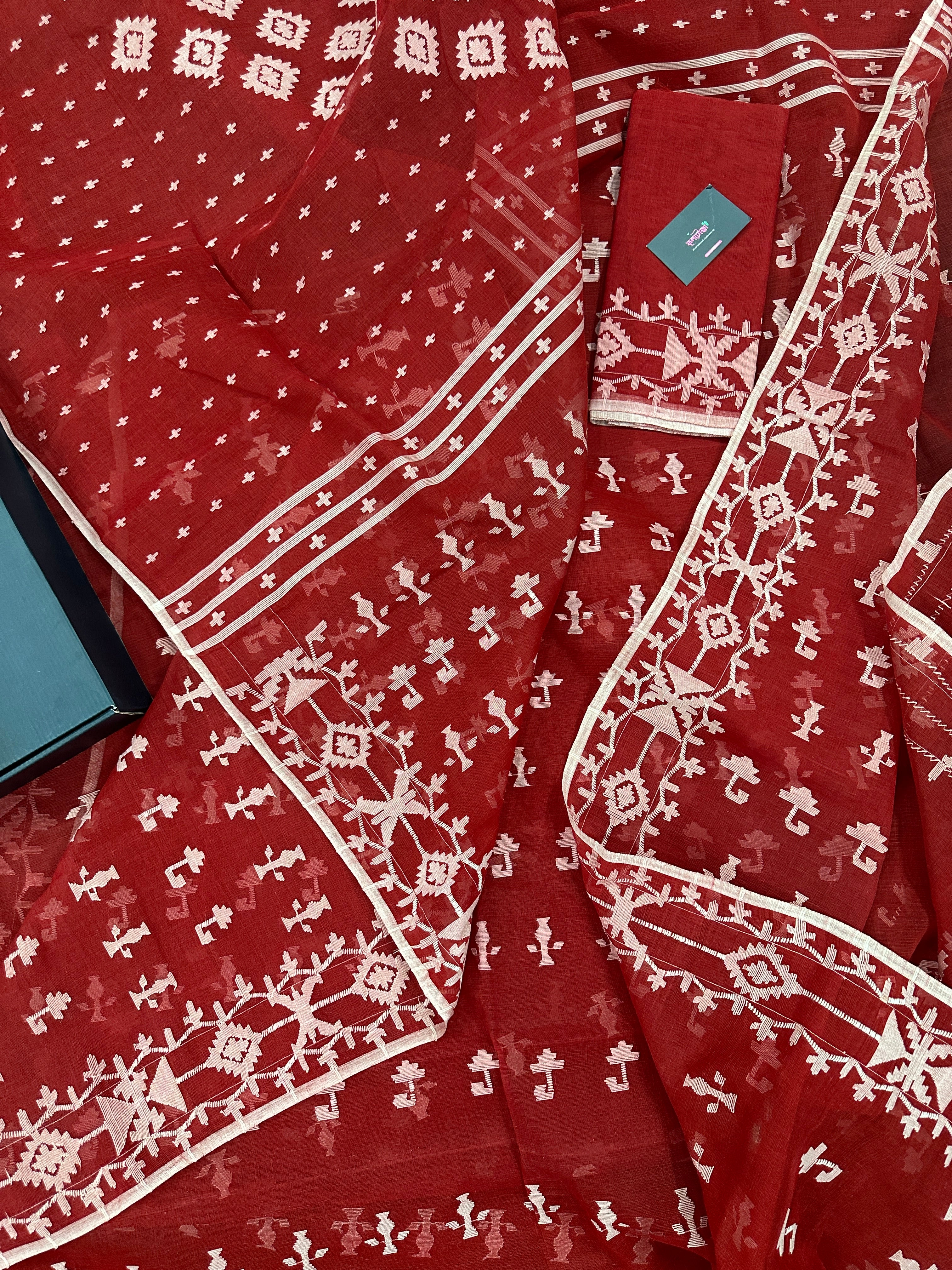 Maroon jamdani saree with white thread work.