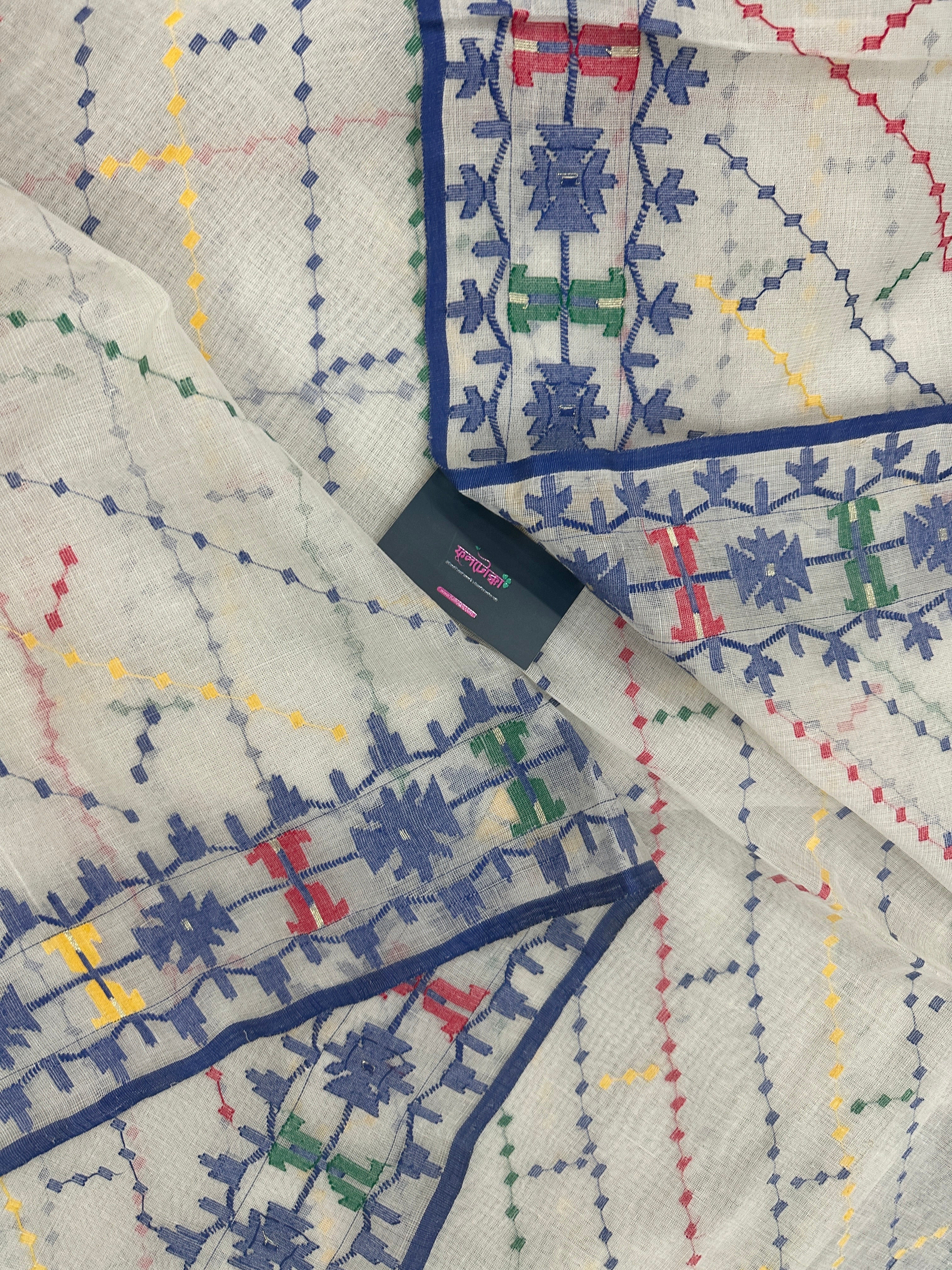 White cotton jamdani saree with blue yellow red green threads work& blouse piece.