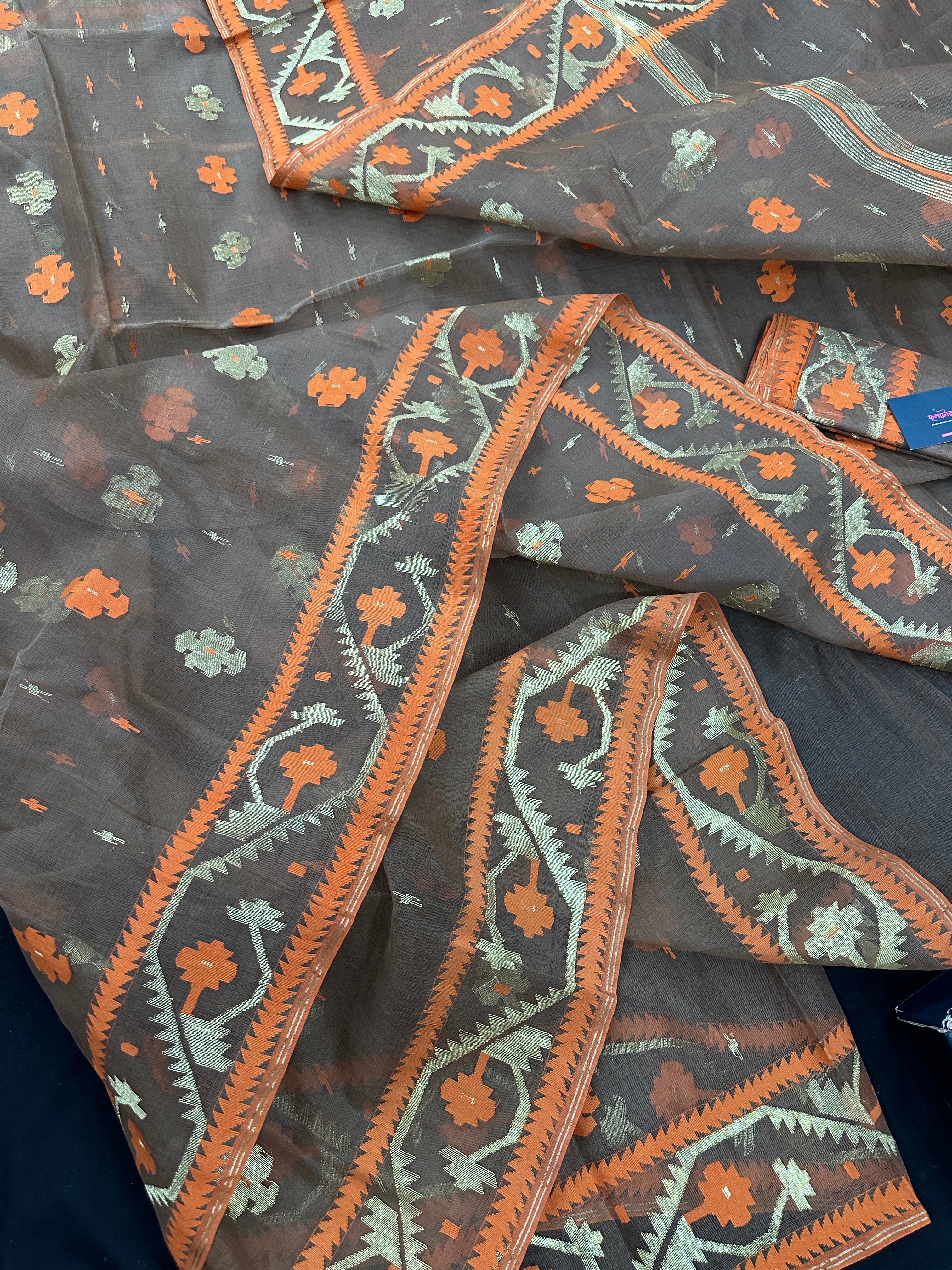 Peanut Brown dhakai jamdani saree with orange threads work & golden jori work all over soft count.