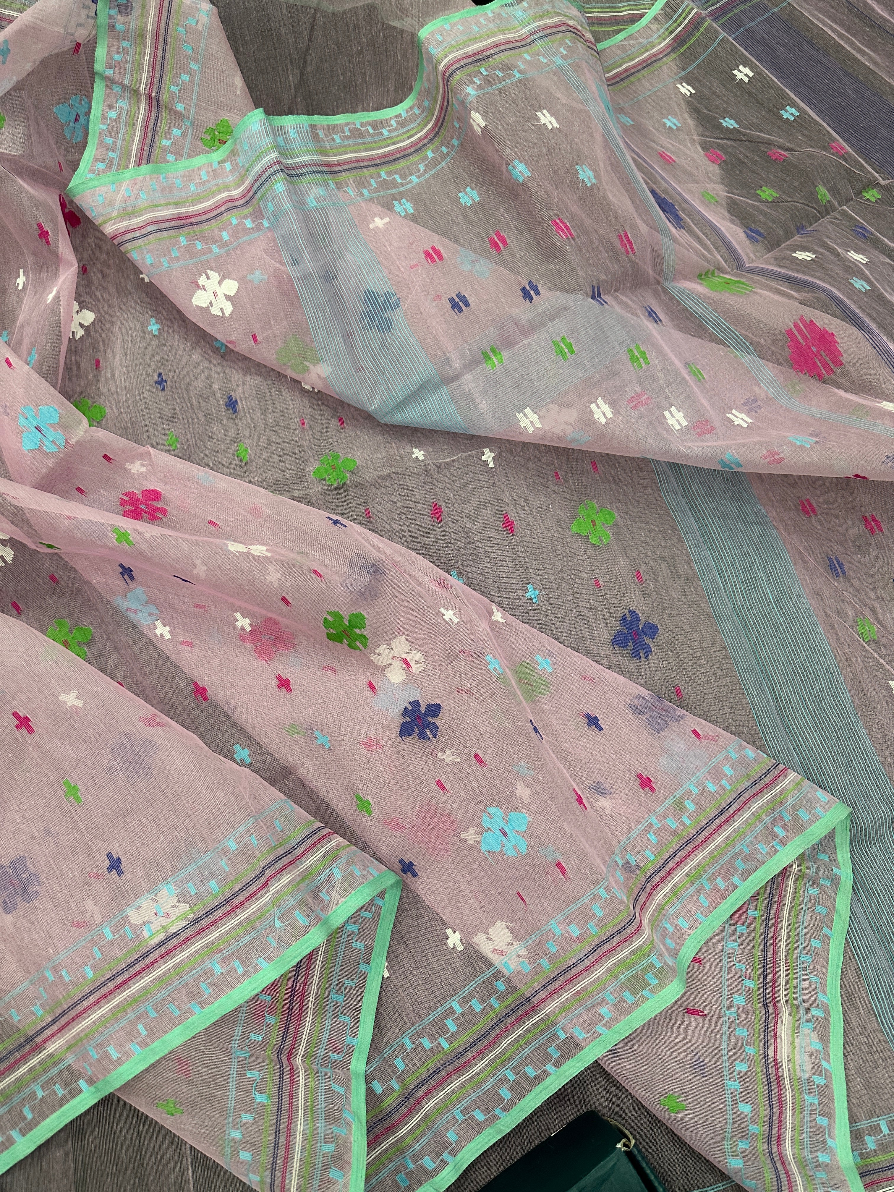 Baby pink jamdani saree with blue pink green threats work and blouse piece.