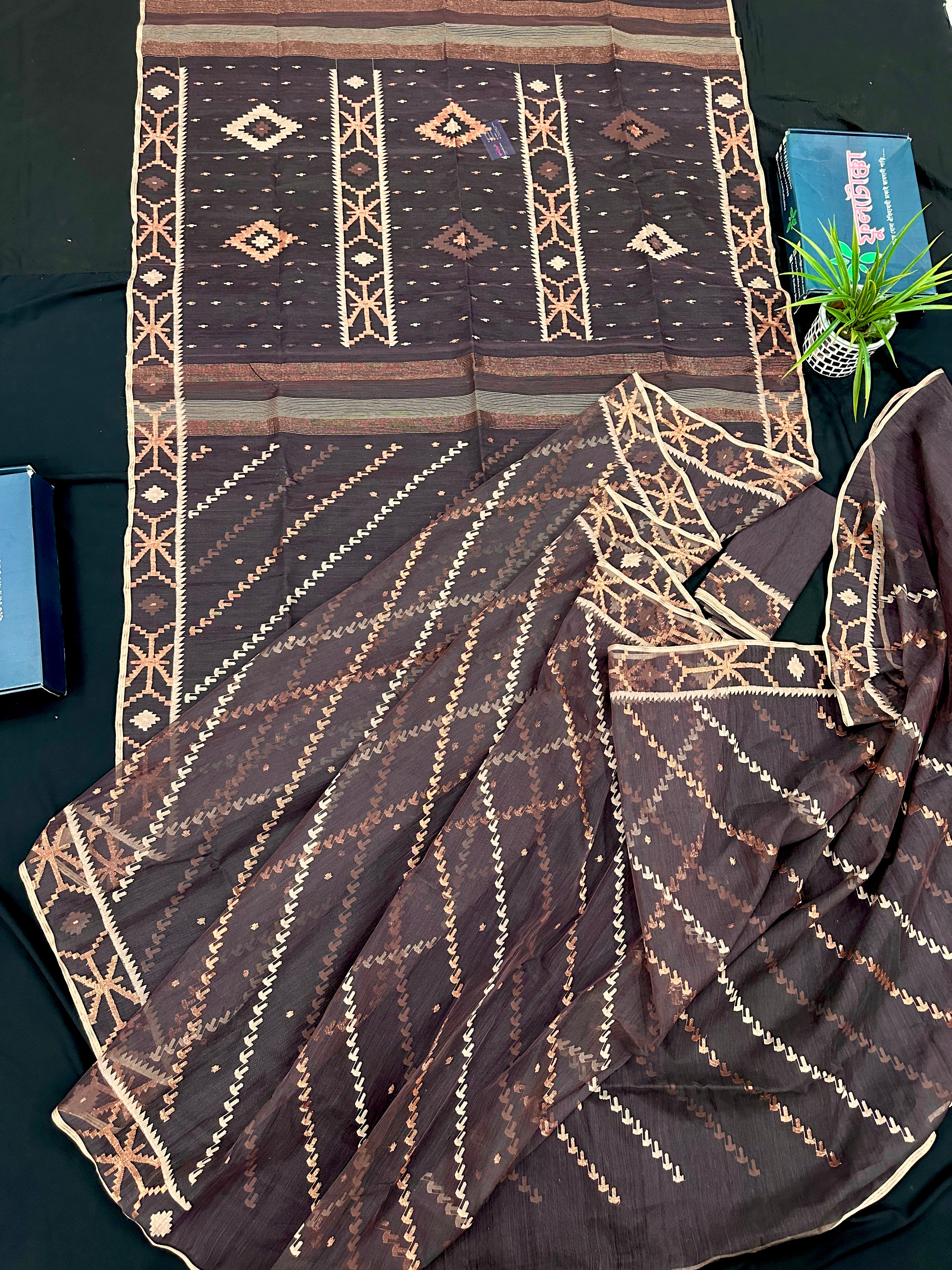 Brown colour jamdani saree with brown & off white threads work.