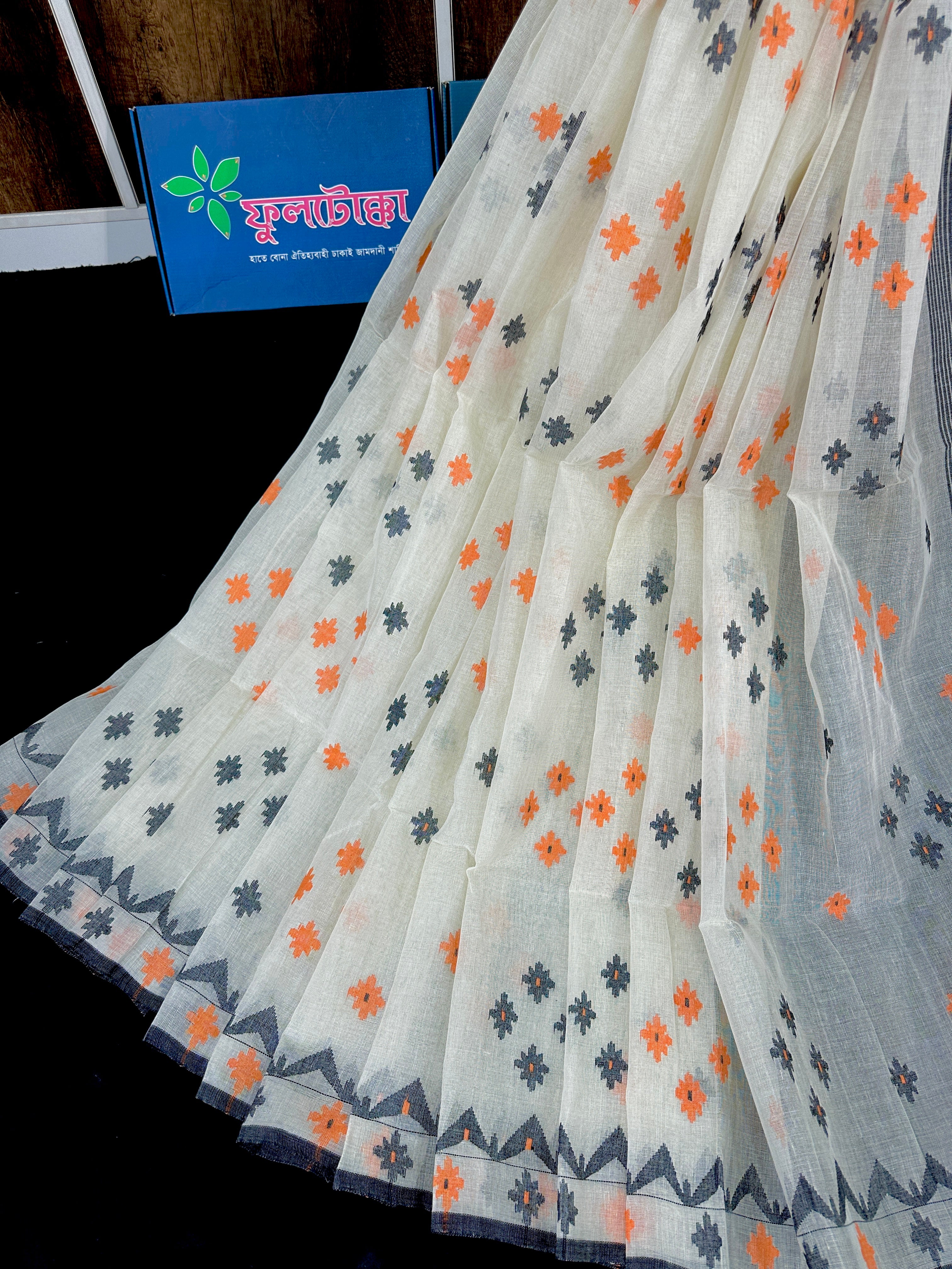 White cotton jamdani saree with orange & black threads work.