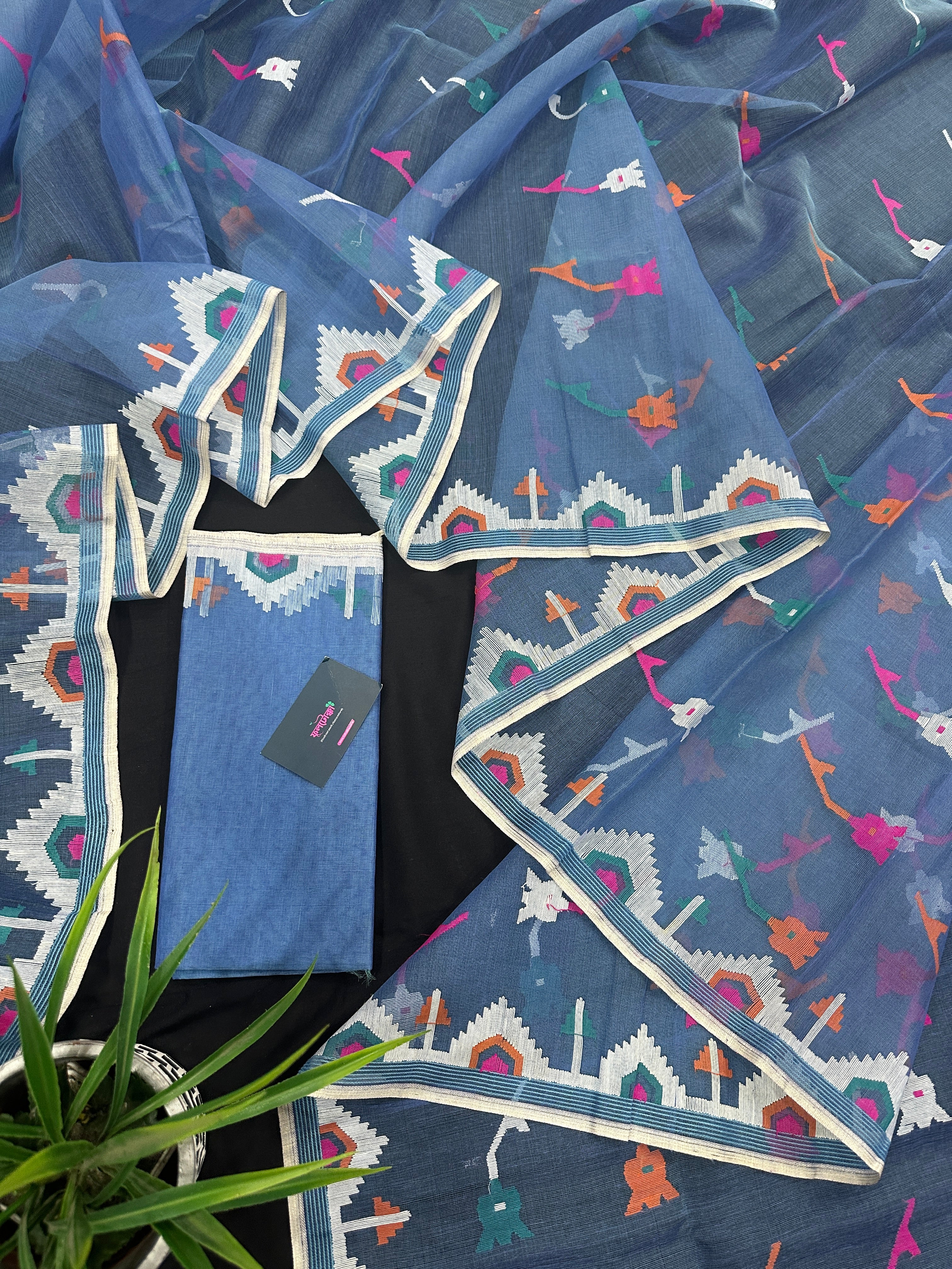 Dusty blue jamdani saree with pink white blue green work and white paar.