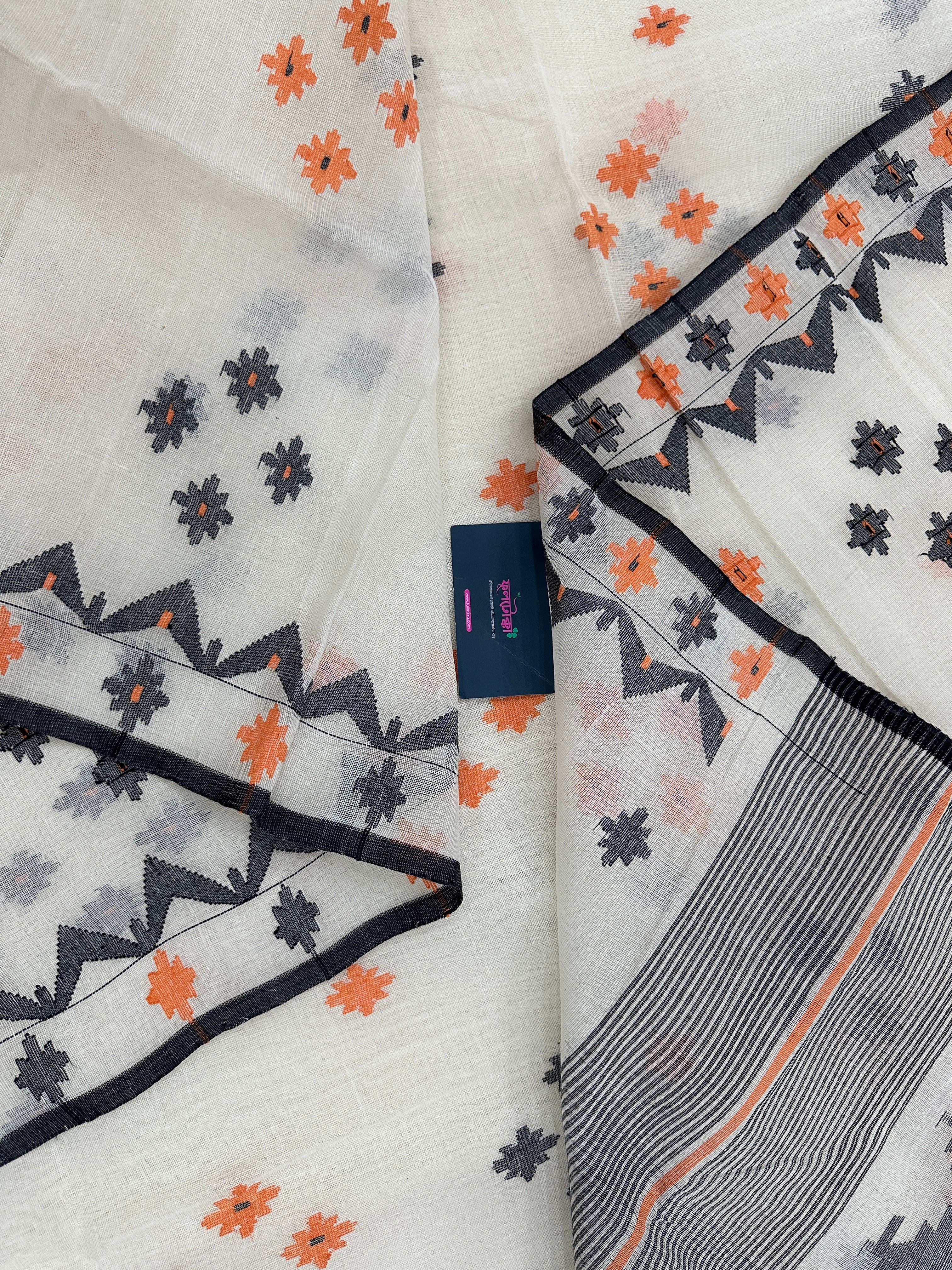 White cotton jamdani saree with orange & black threads work.