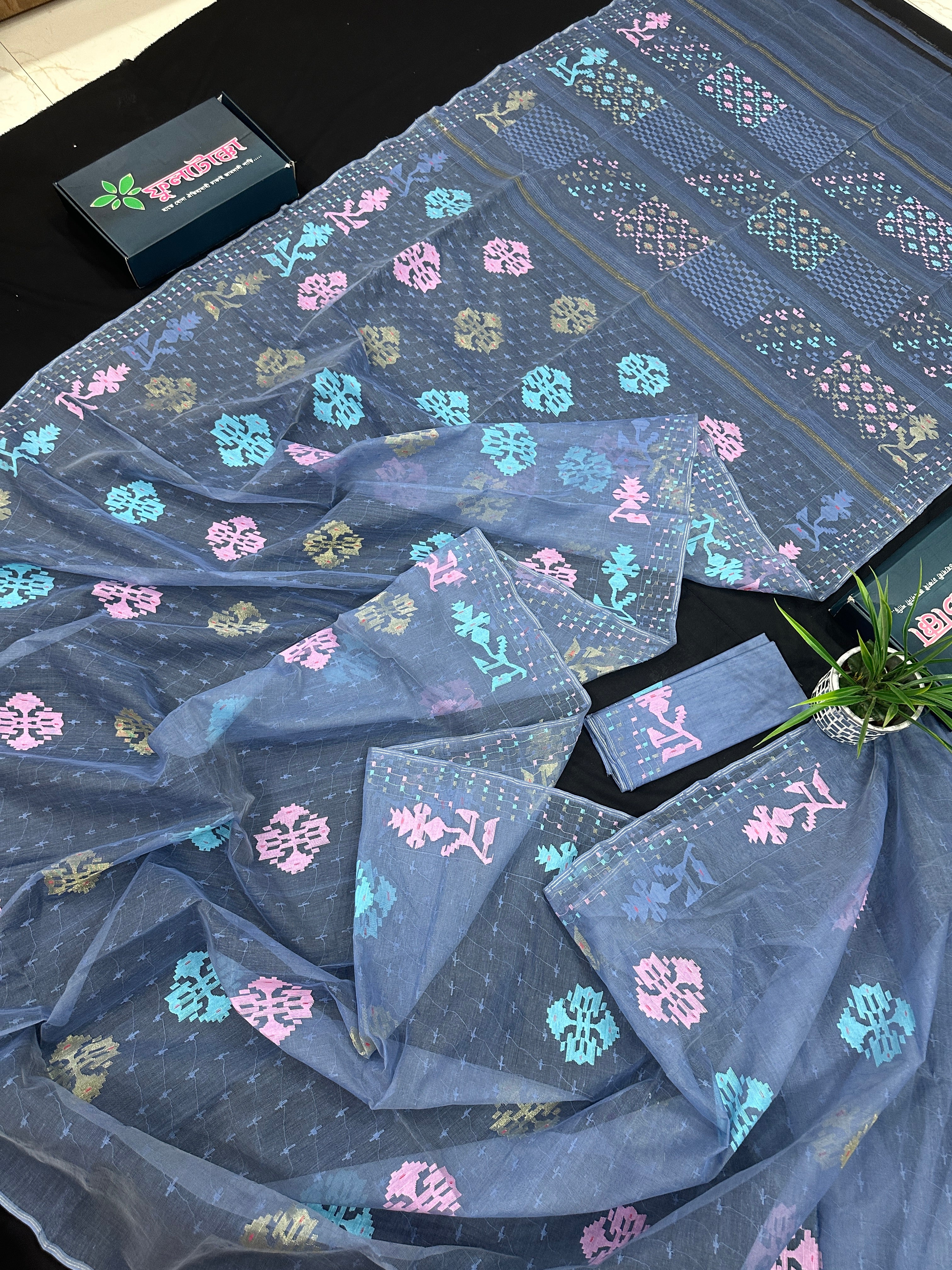 Powdery blue jamdani saree with pink blue and golden jori work.