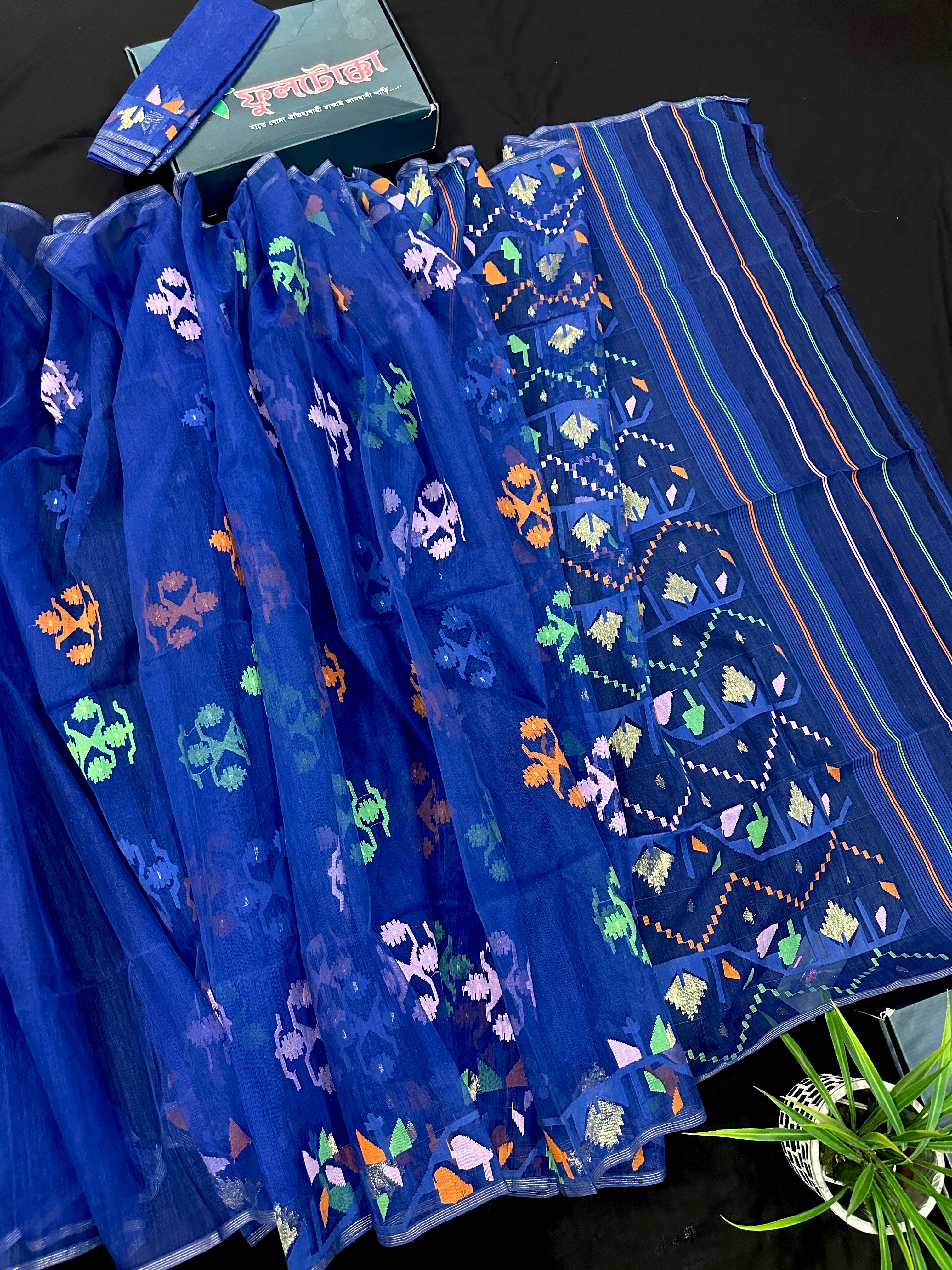 Royal blue jamdani saree with green pink blue orange threads work.