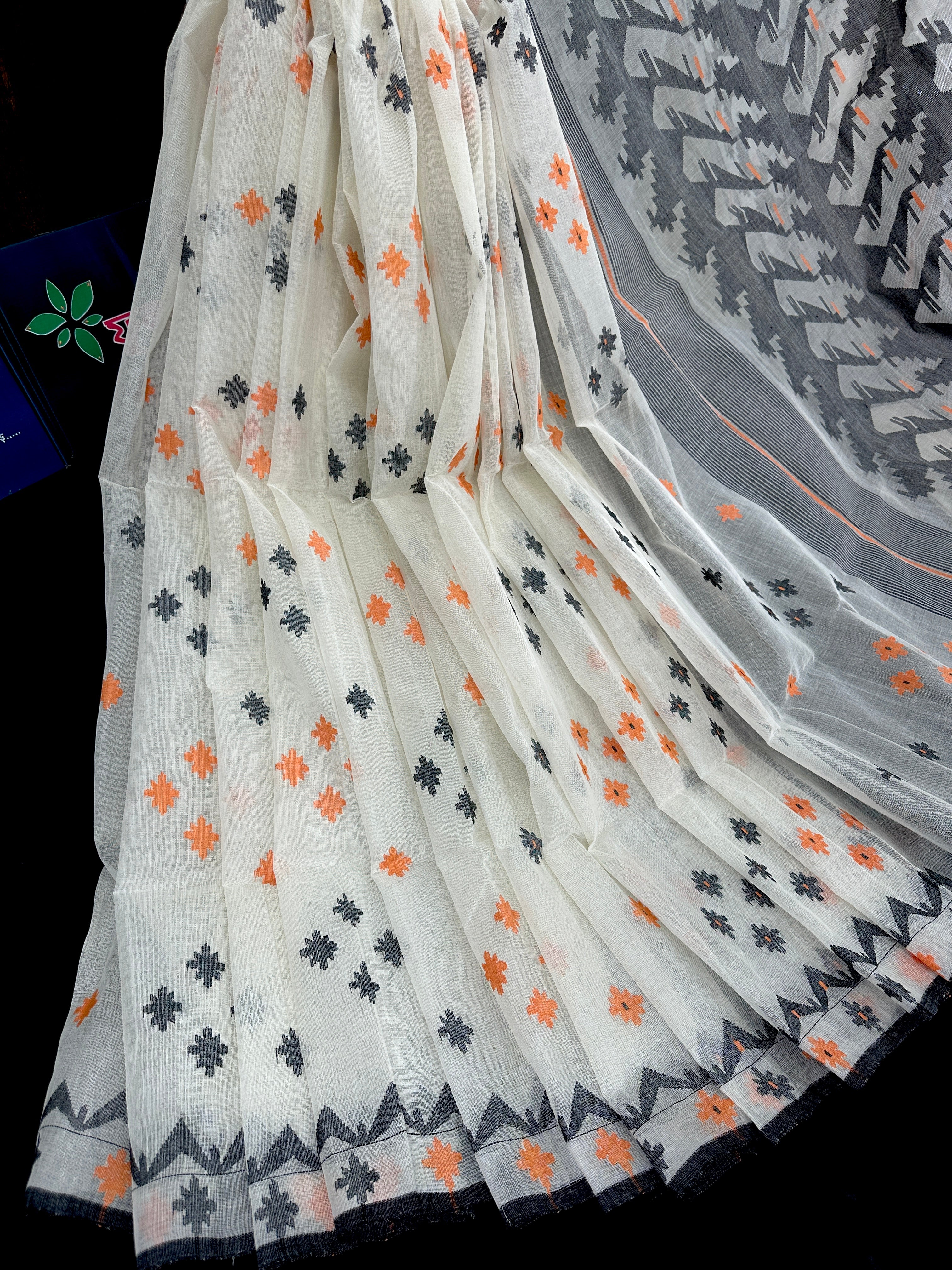 White cotton jamdani saree with orange & black threads work.