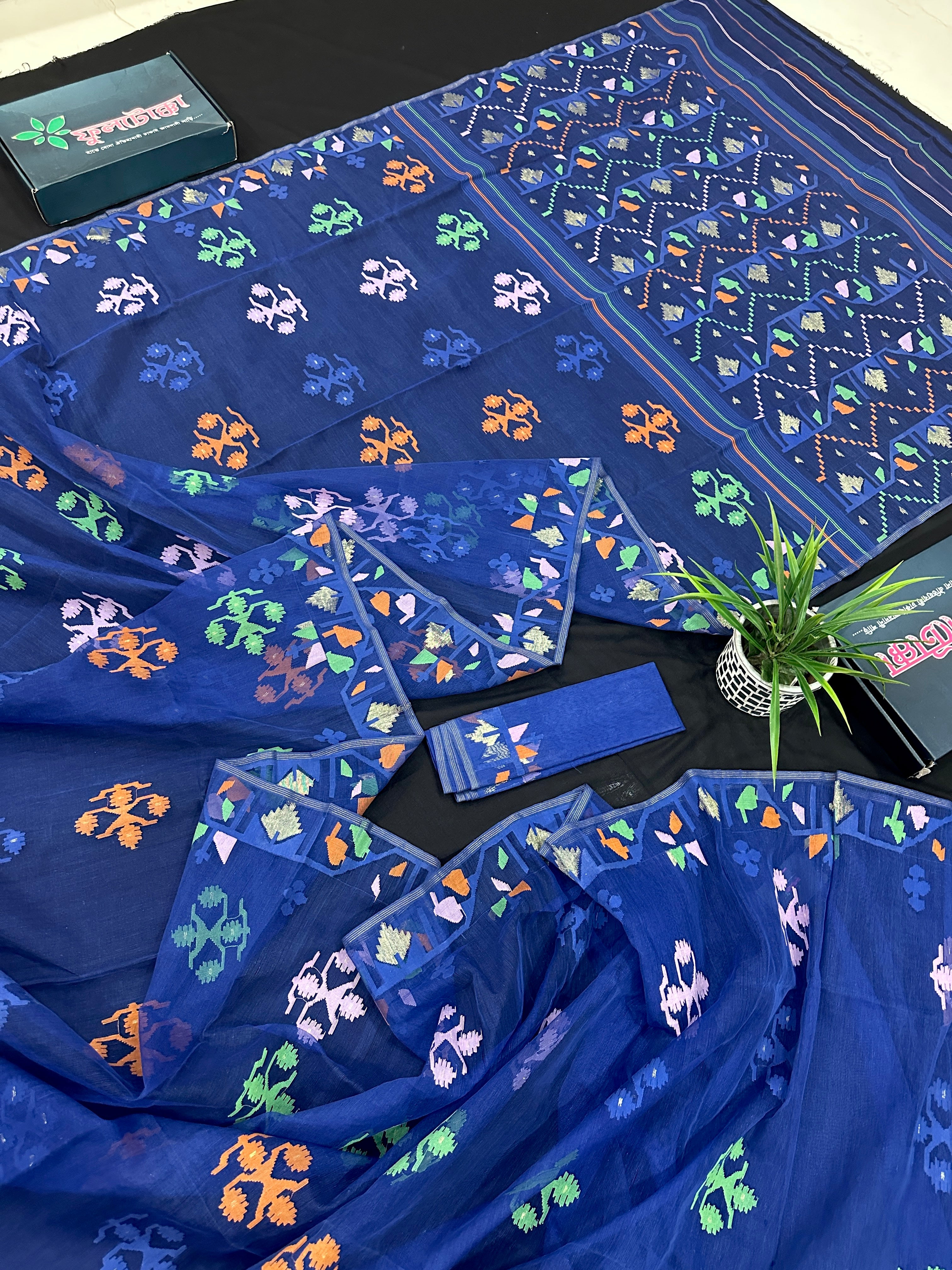 Royal blue jamdani saree with green pink blue orange threads work.