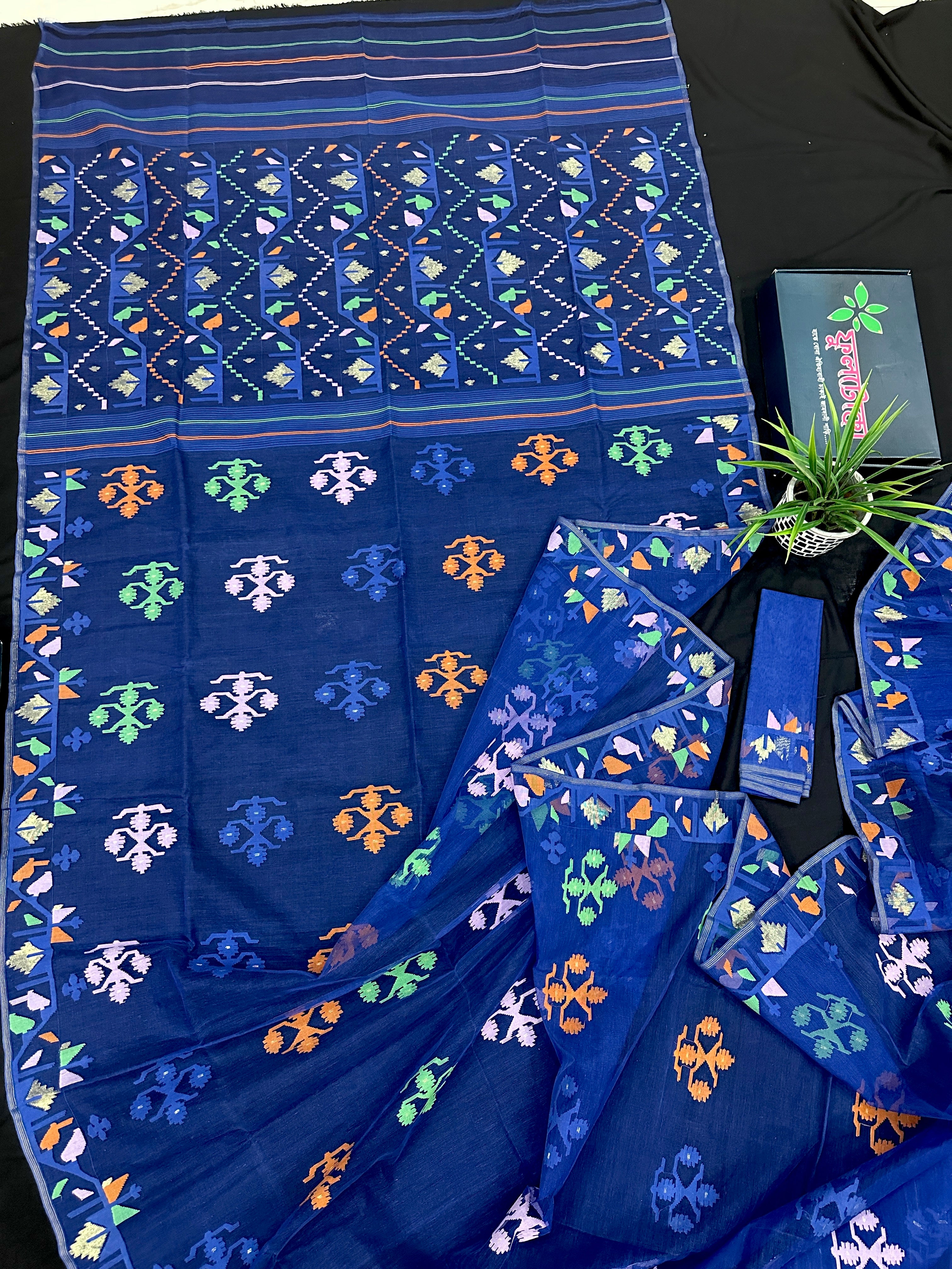 Royal blue jamdani saree with green pink blue orange threads work.