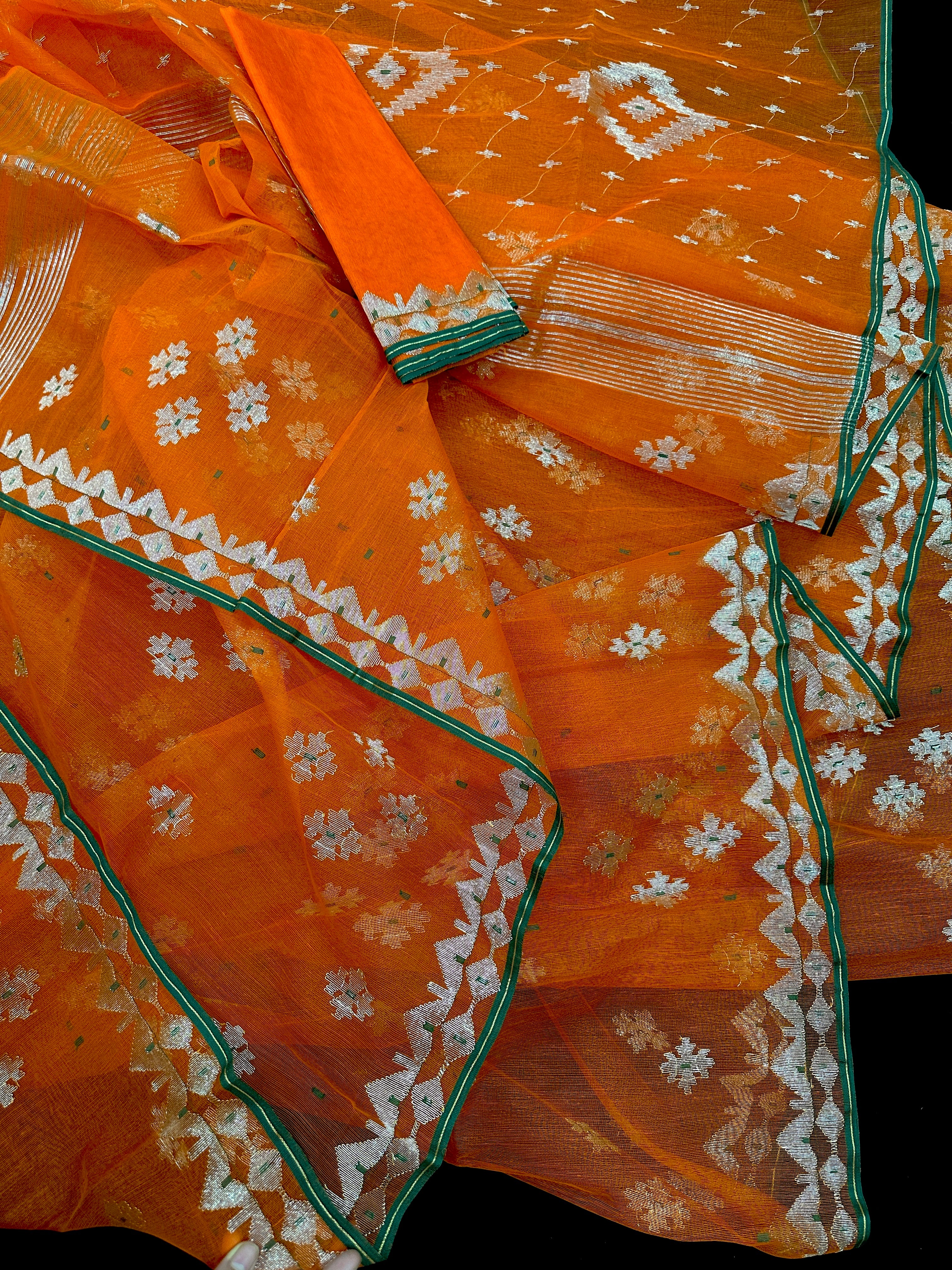 Orange soft jamdani saree with silver jori work & green border.