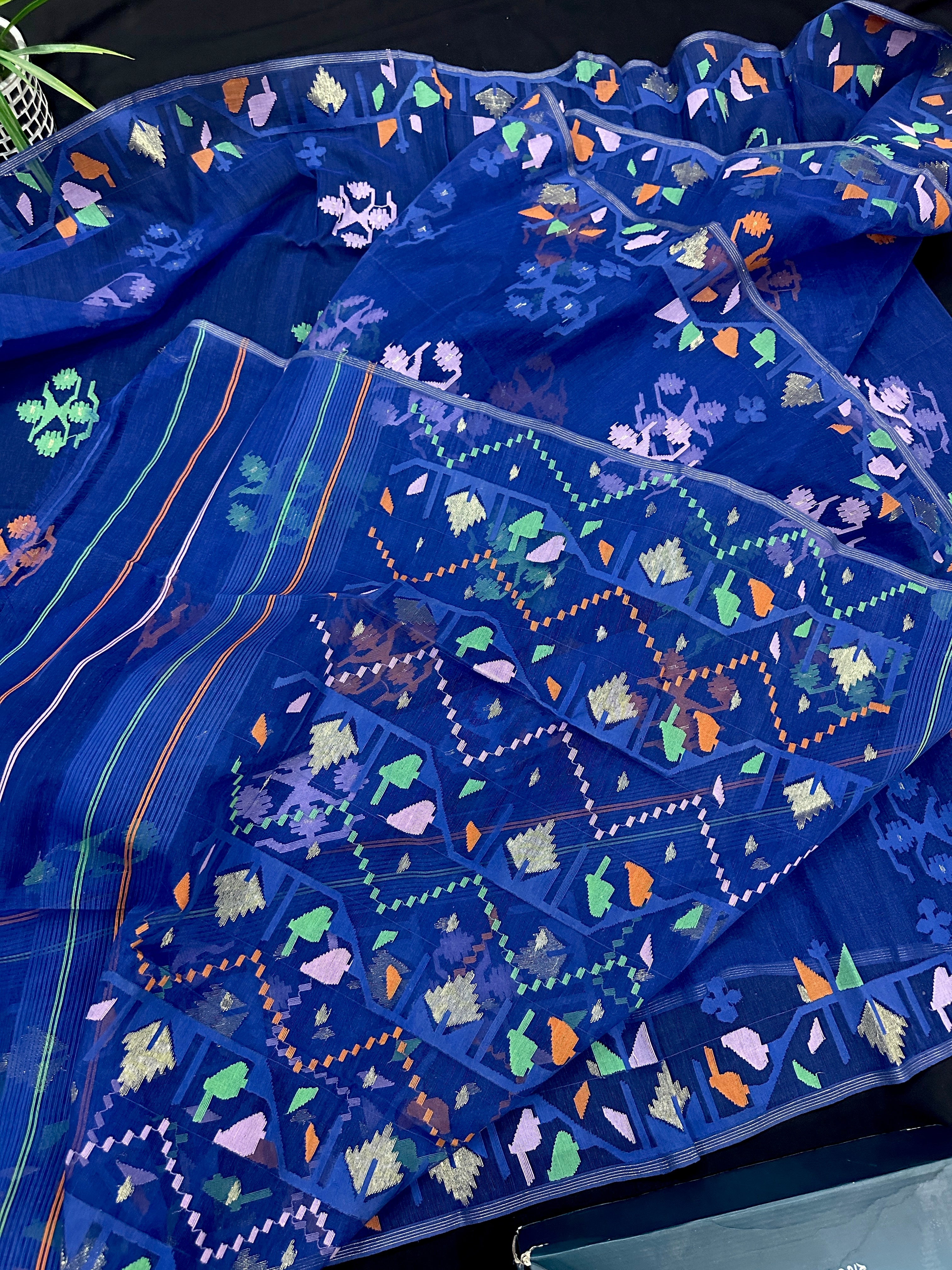 Royal blue jamdani saree with green pink blue orange threads work.