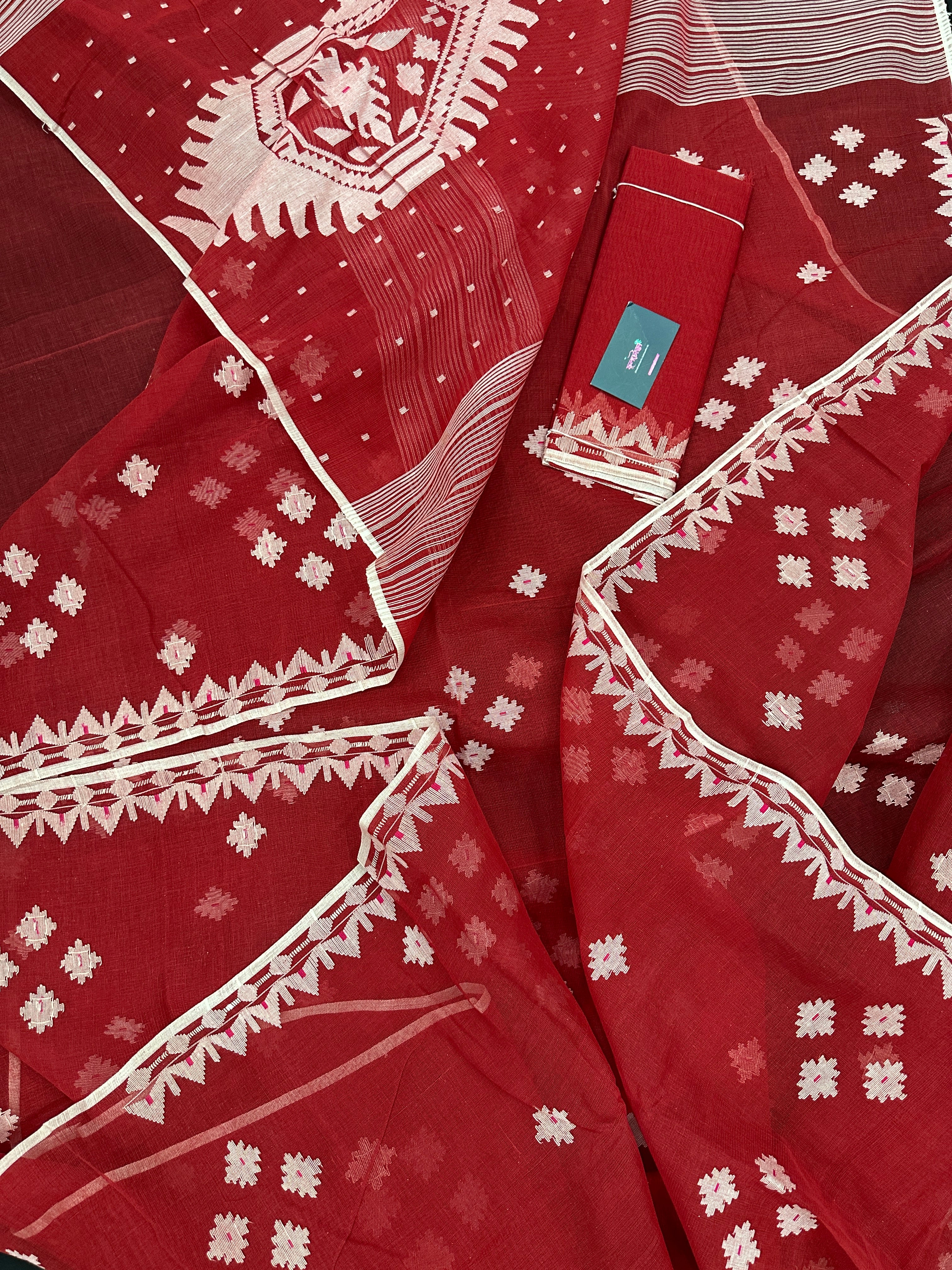 Radish Maroon cotton jamdani saree with white threads work all over work.