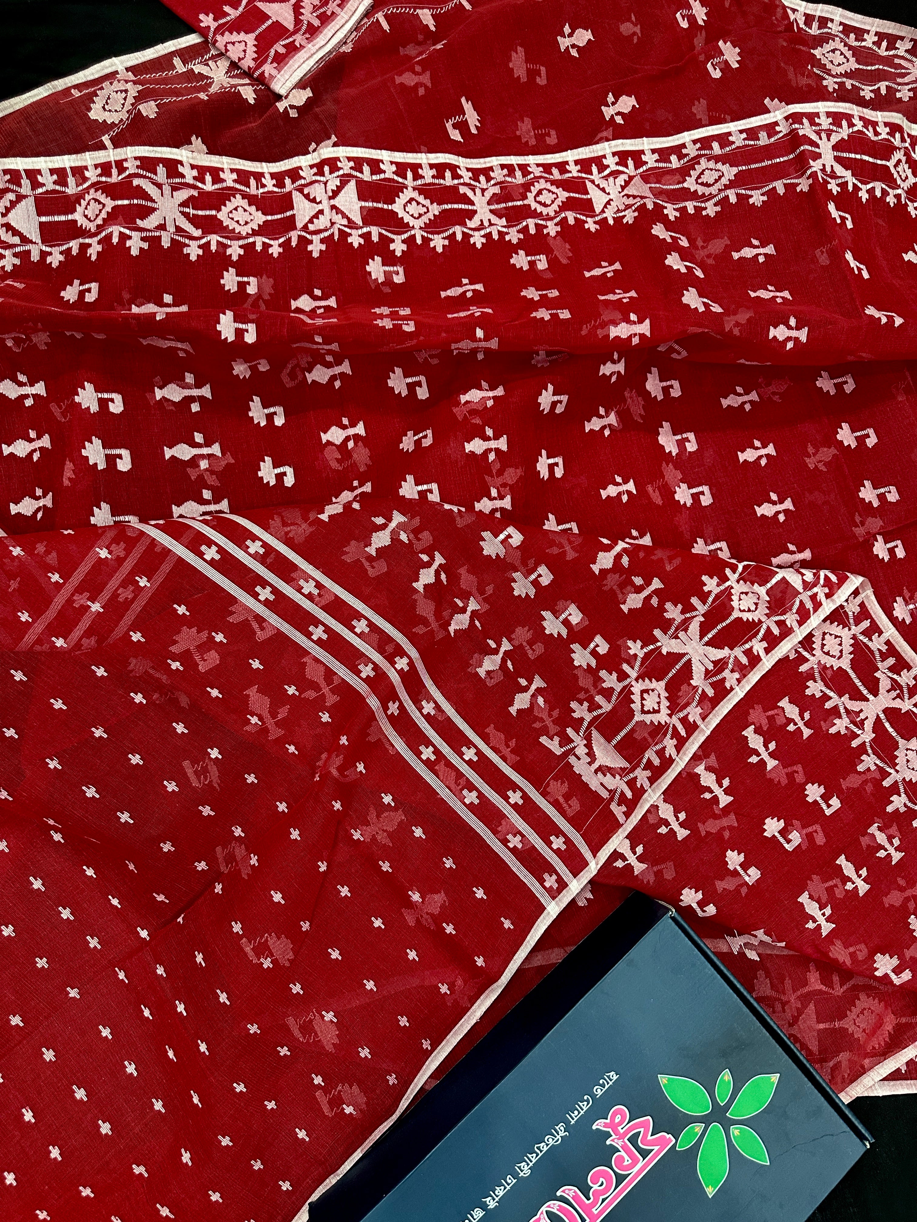 Maroon jamdani saree with white thread work.