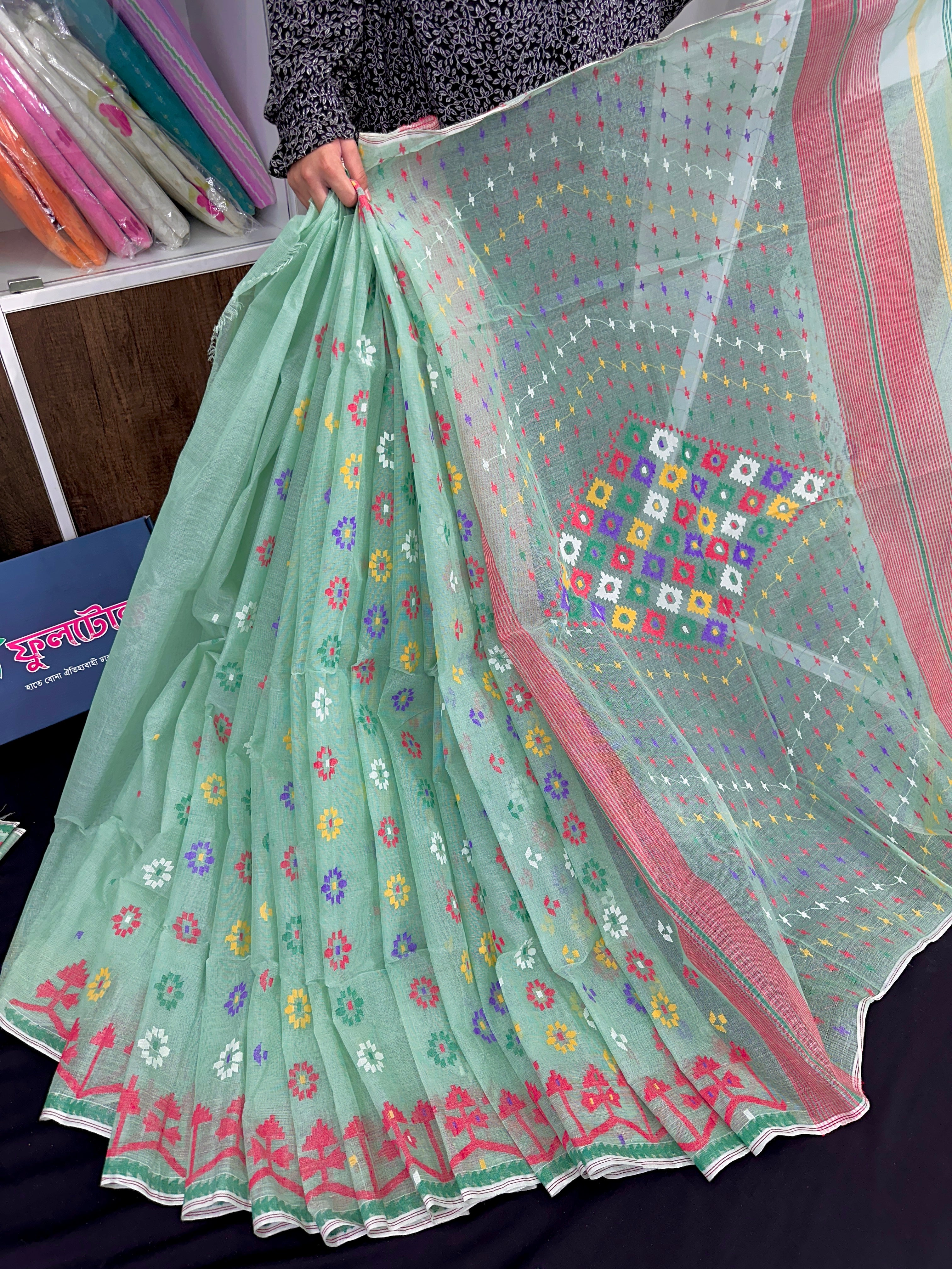 Mint cotton jamdani saree with yellow blue purple red white floral work.