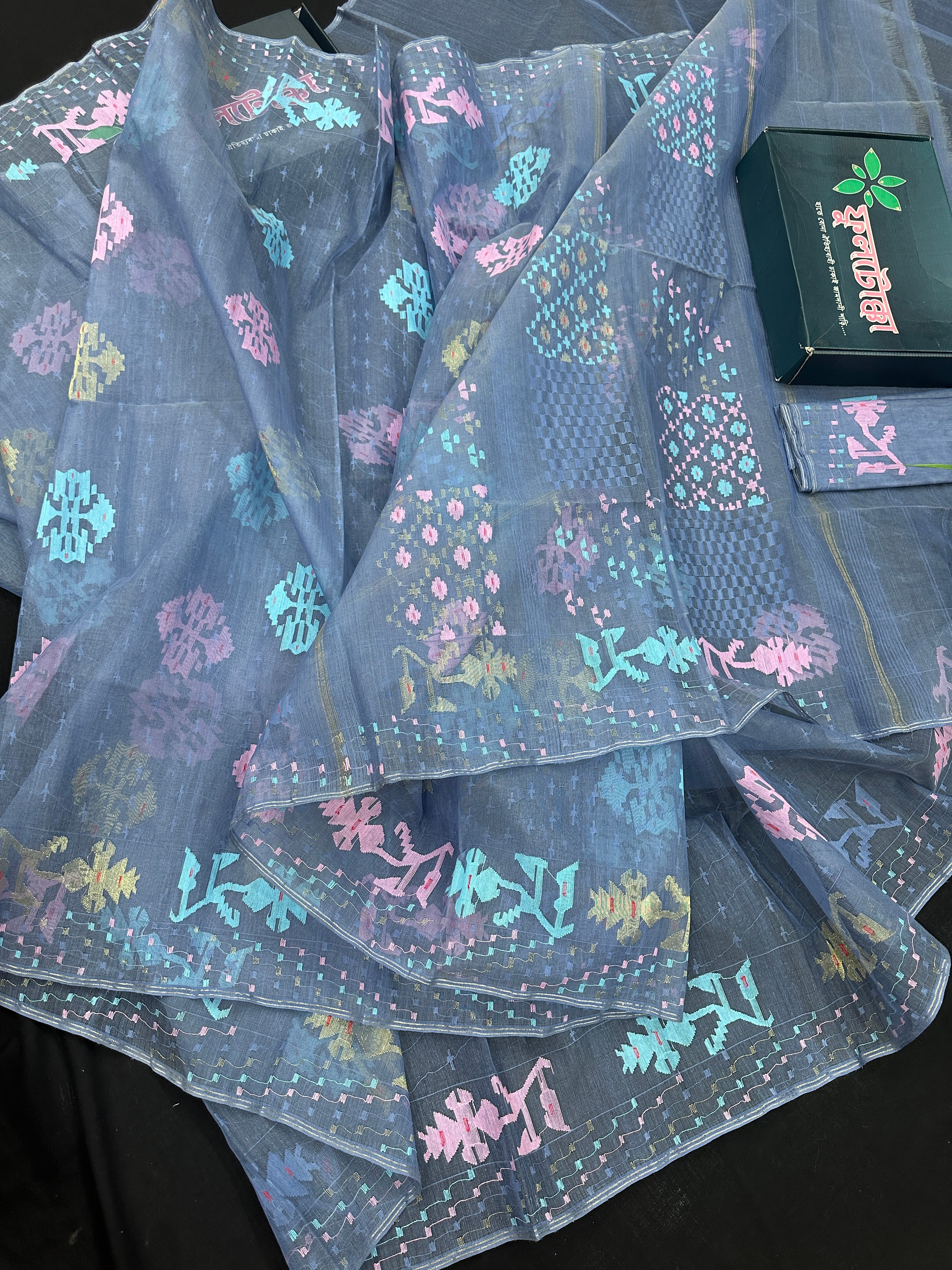Powdery blue jamdani saree with pink blue and golden jori work.