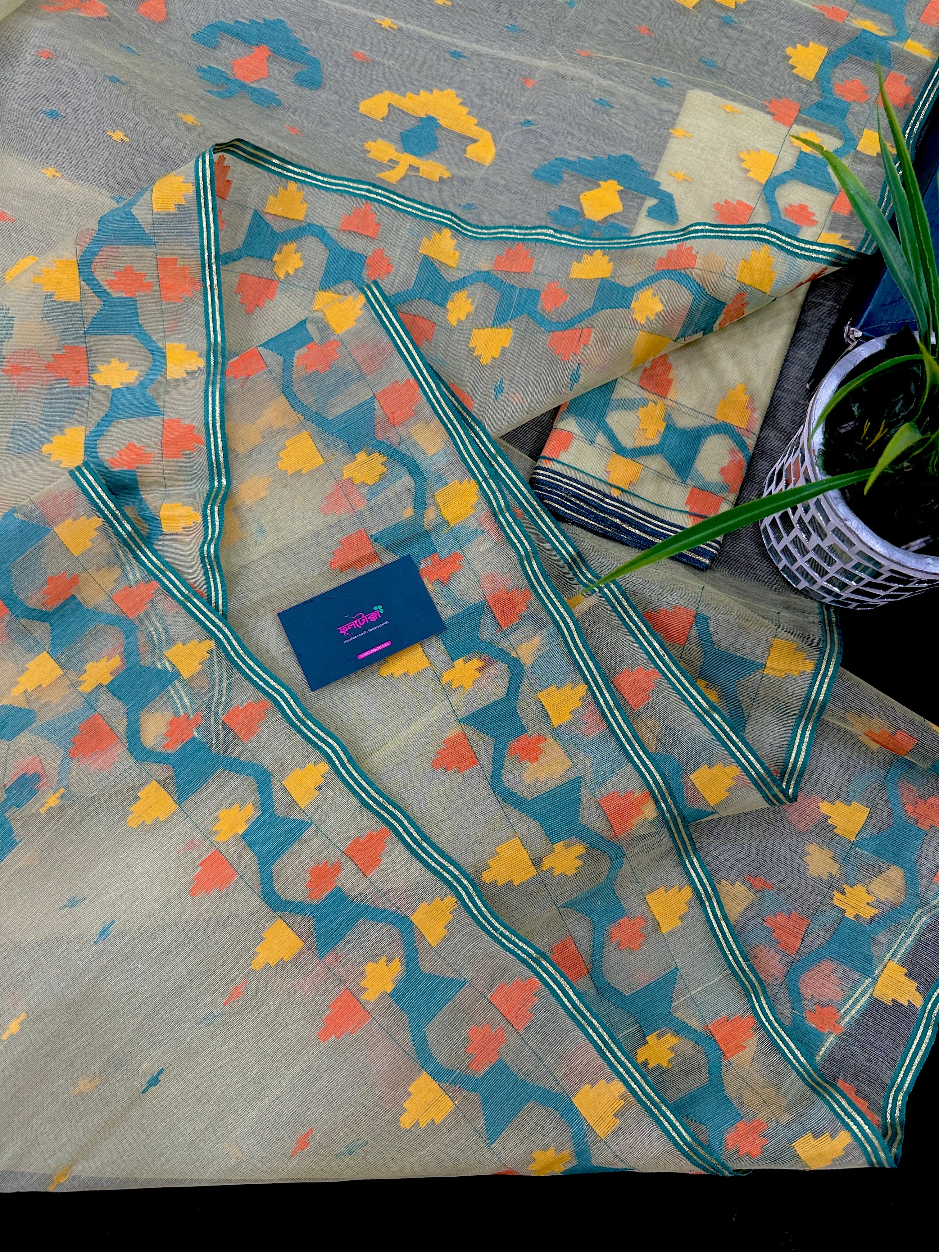 Cream colour jamdani saree with yellow orange blue floral threads work and blouse piece.