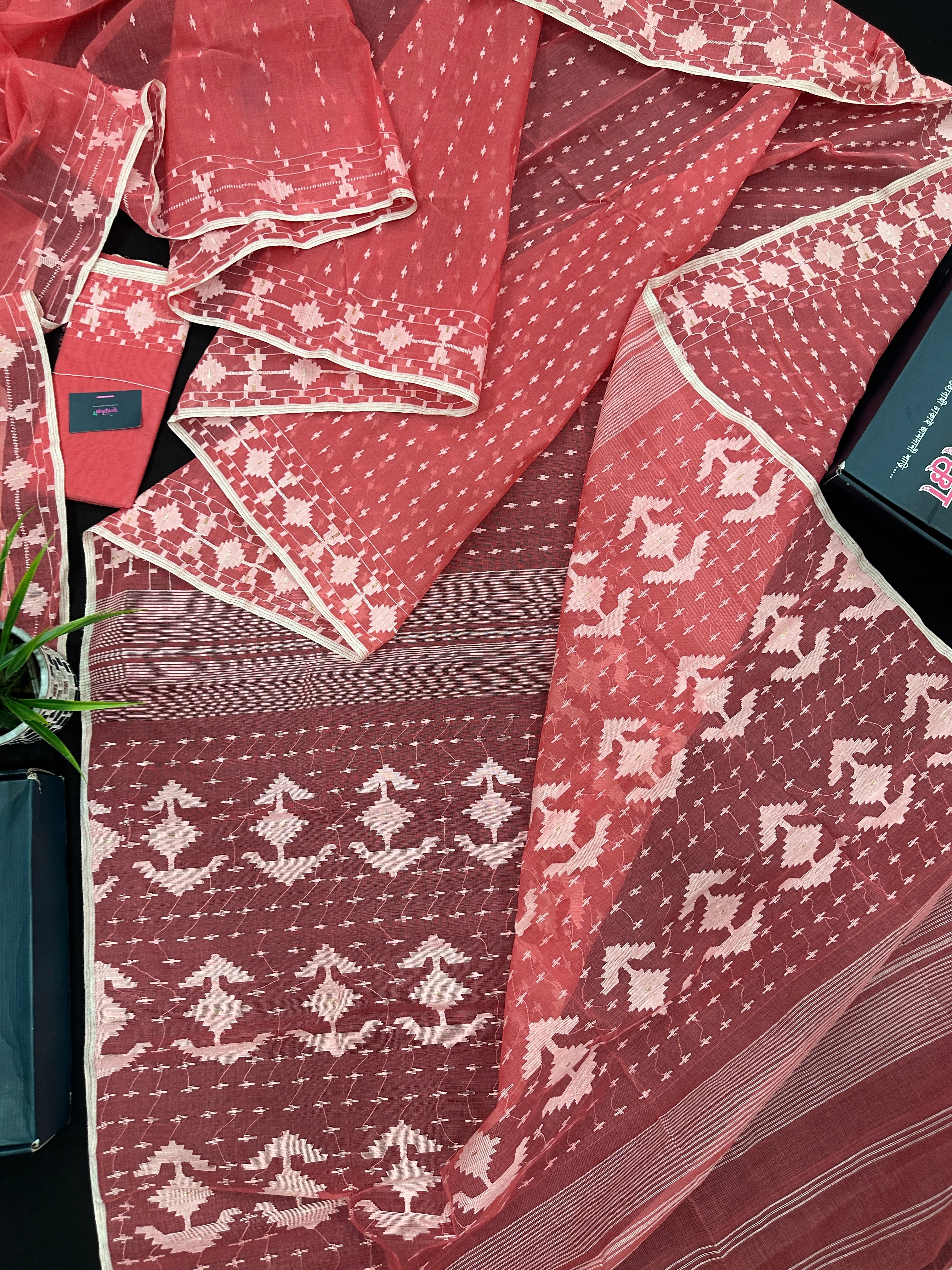 Sweet pink cotton jamdani saree with white threads work and blouse piece.