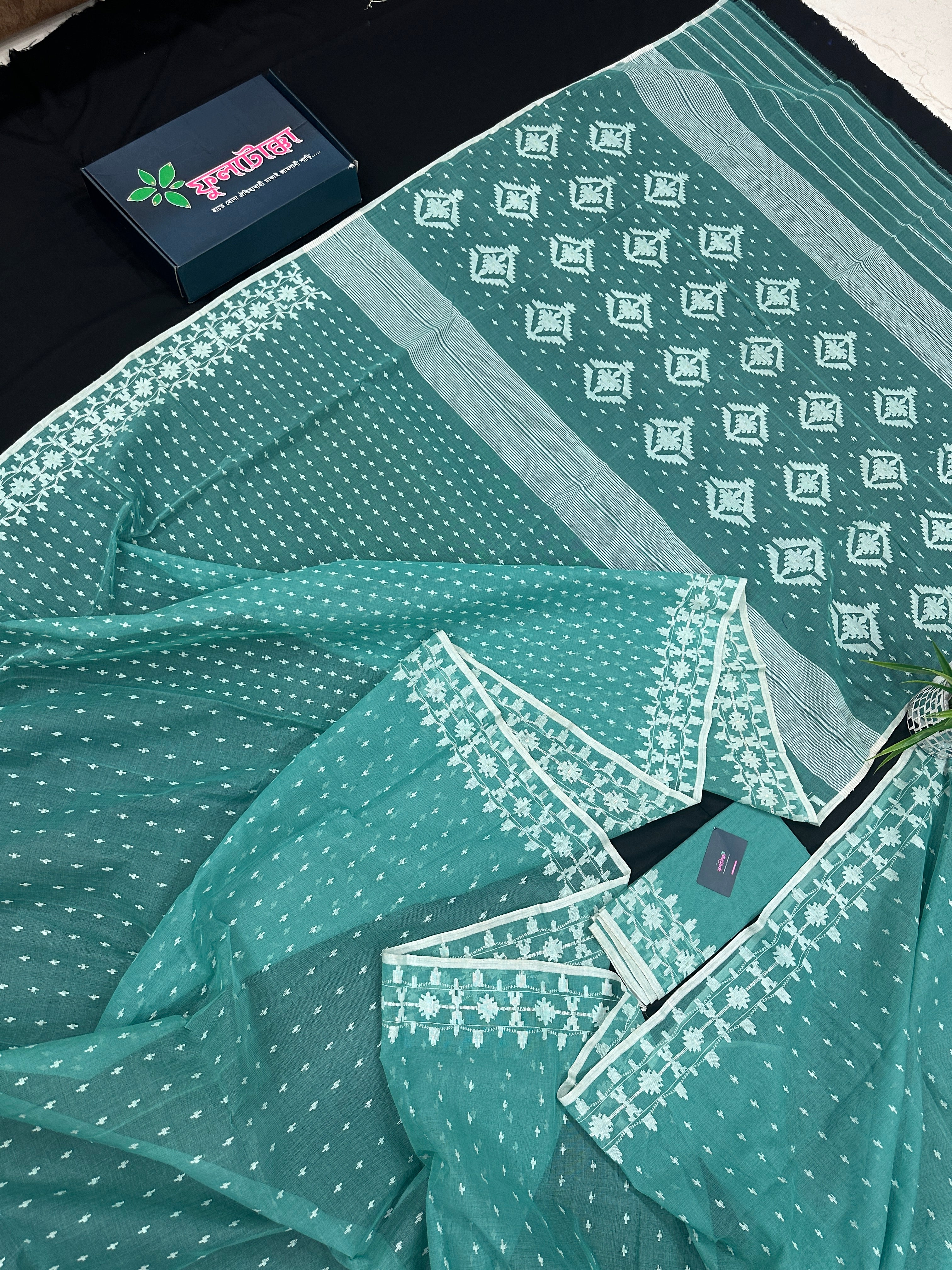 Mint cotton jamdani saree with white threads work all over work and blouse piece.