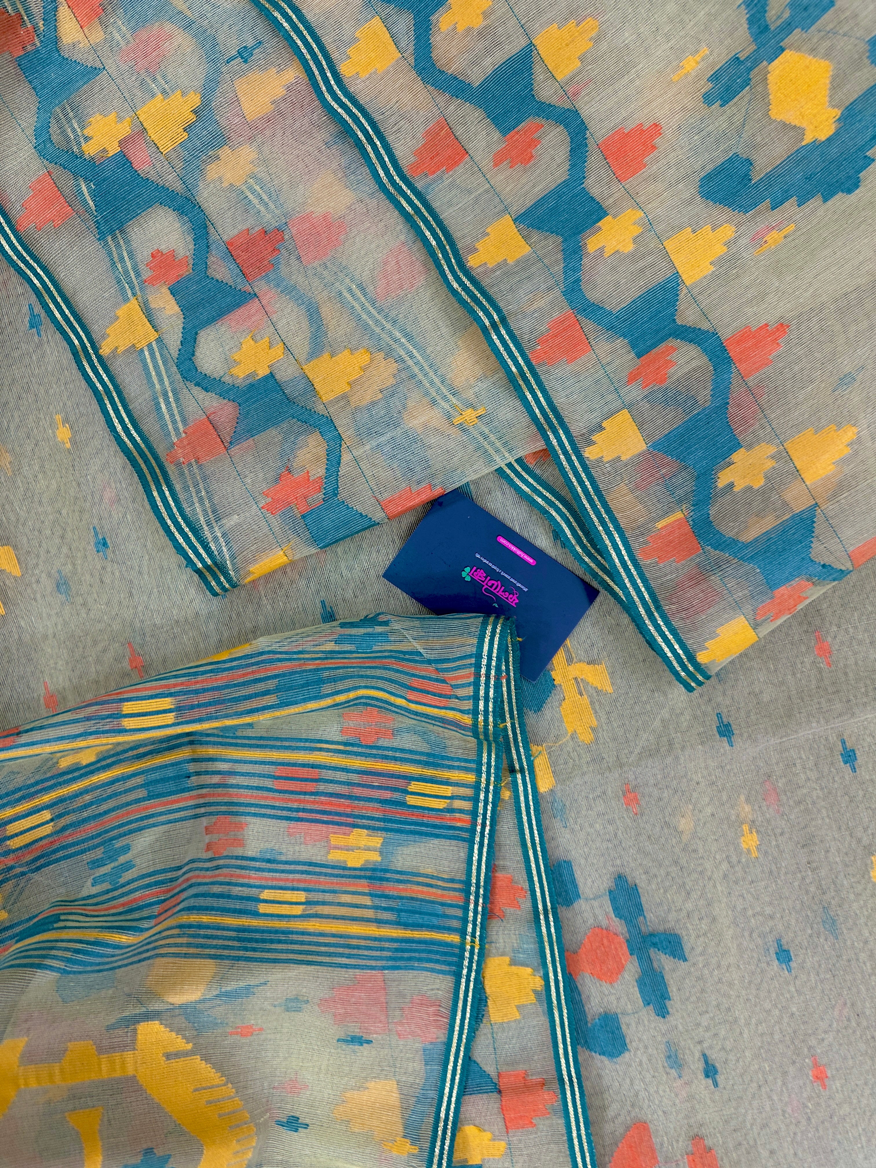 Cream colour jamdani saree with yellow orange blue floral threads work and blouse piece.
