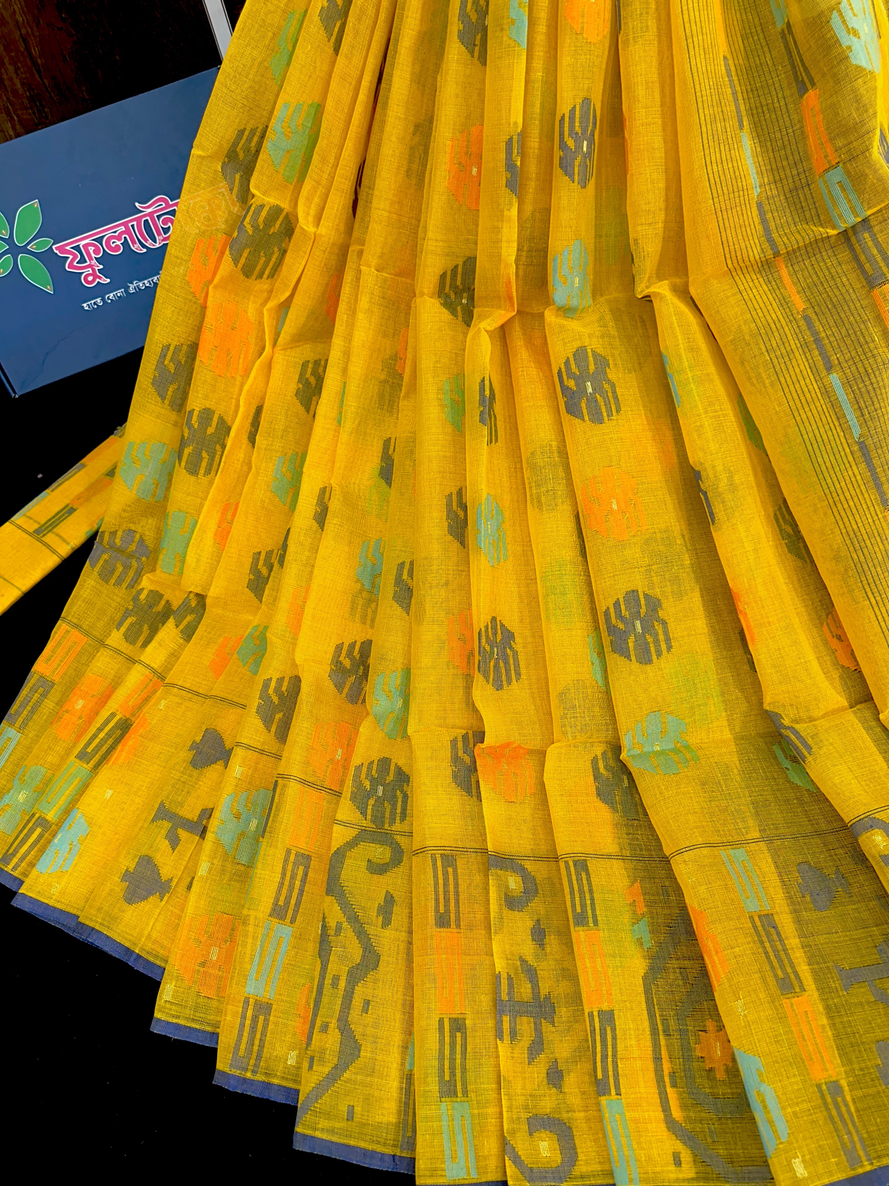 Yellow cotton jamdani saree with orange grey green blue colour threads work.