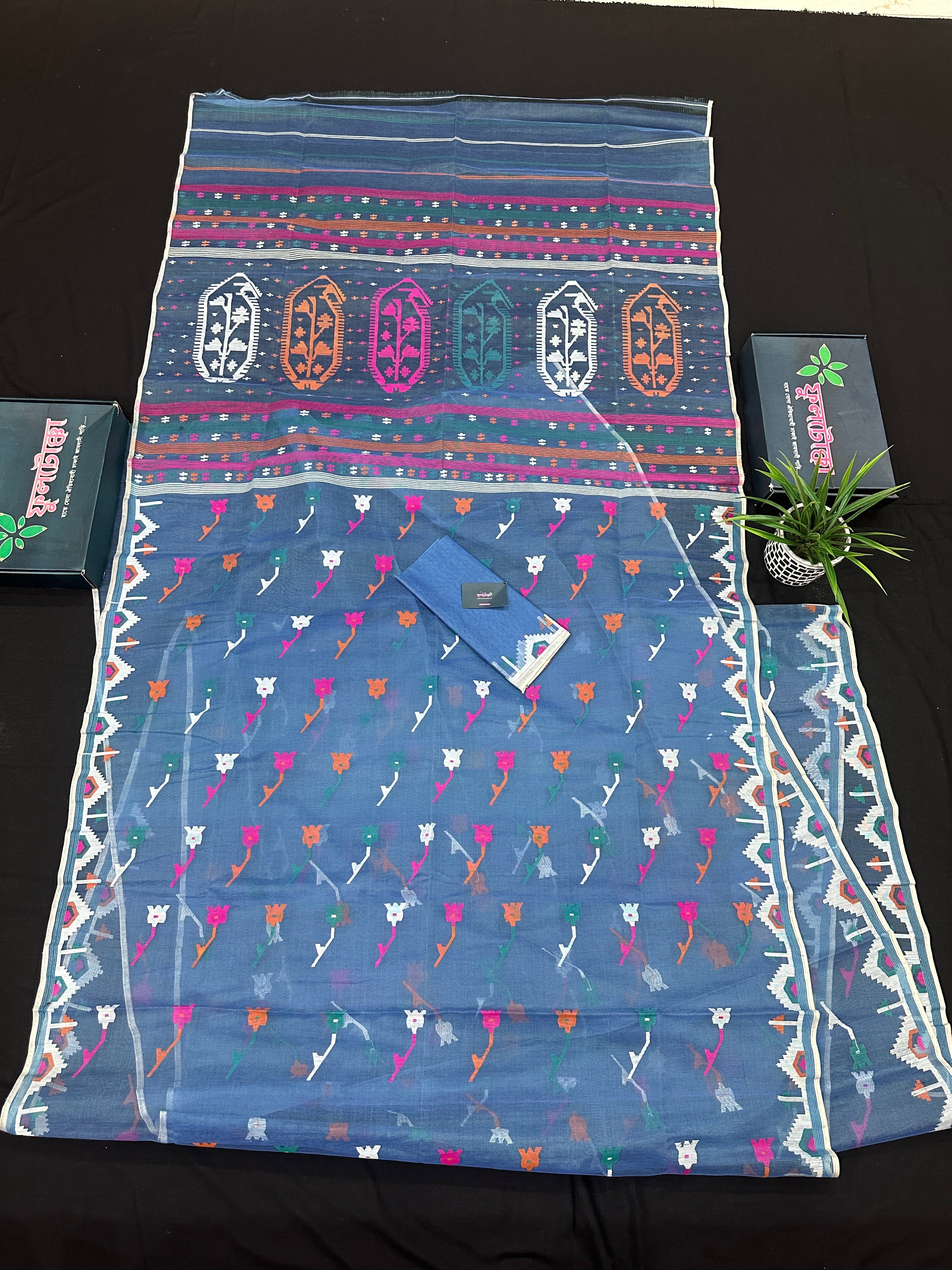 Dusty blue jamdani saree with pink white blue green work and white paar.