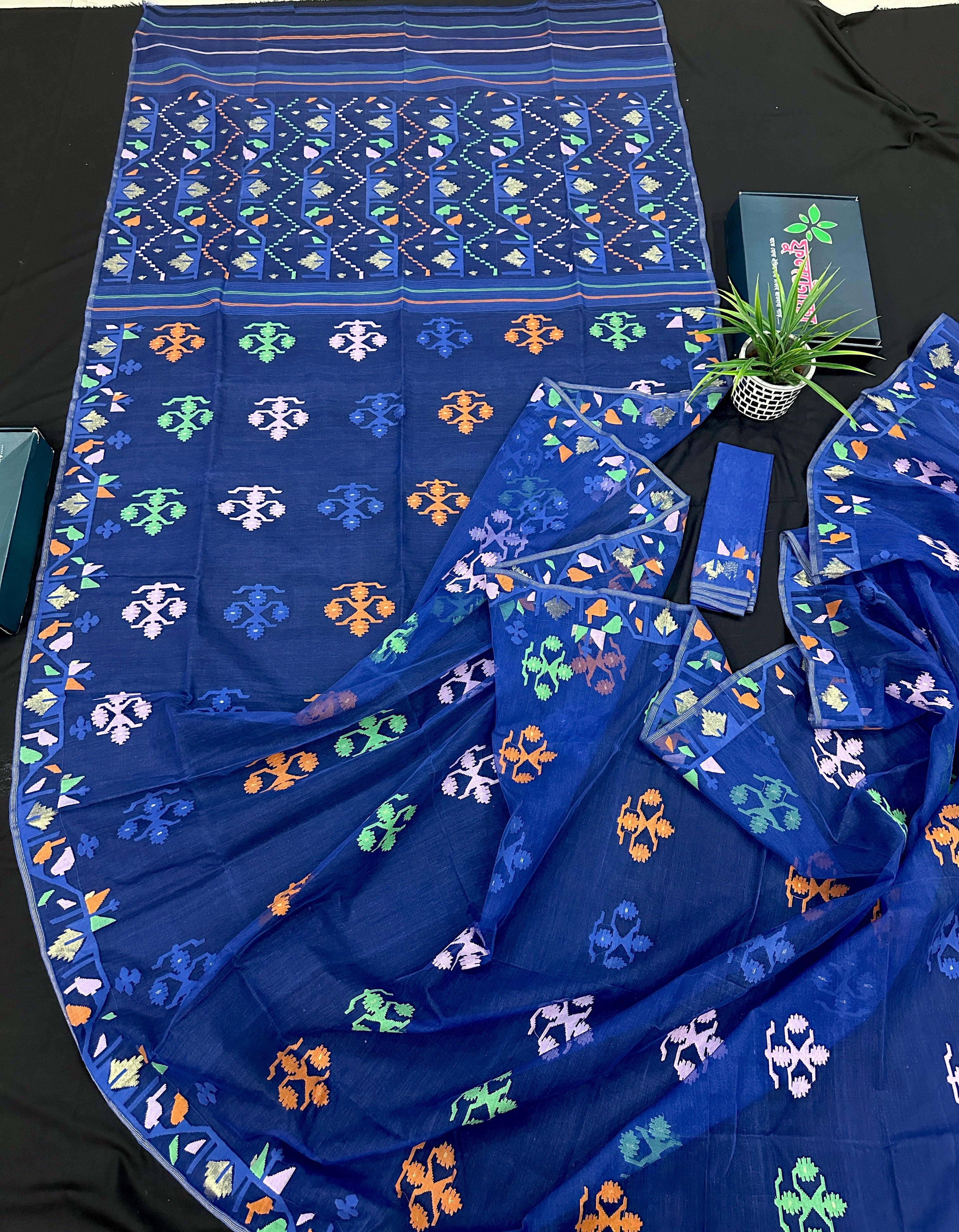 Royal blue jamdani saree with green pink blue orange threads work.
