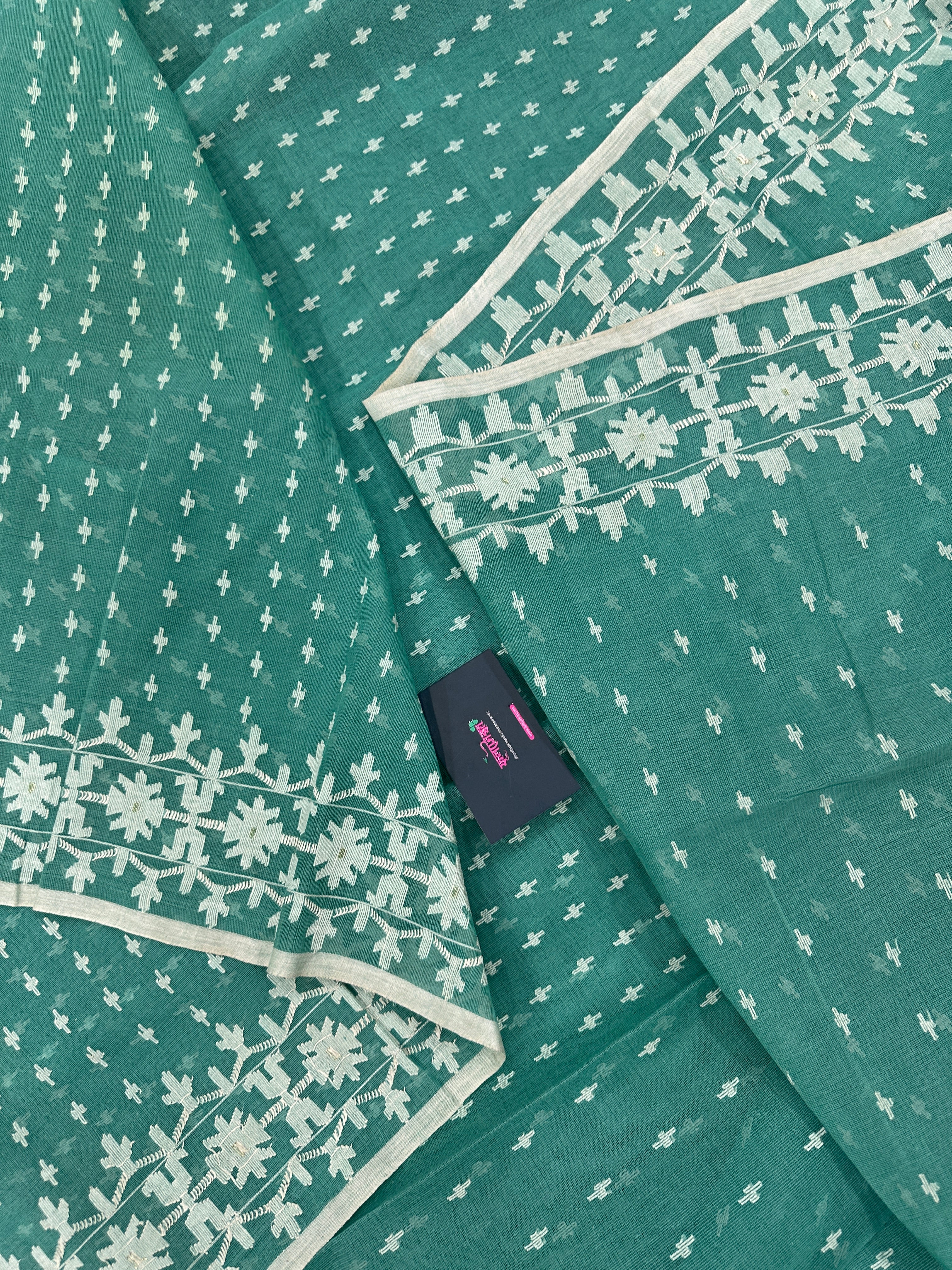 Mint cotton jamdani saree with white threads work all over work and blouse piece.