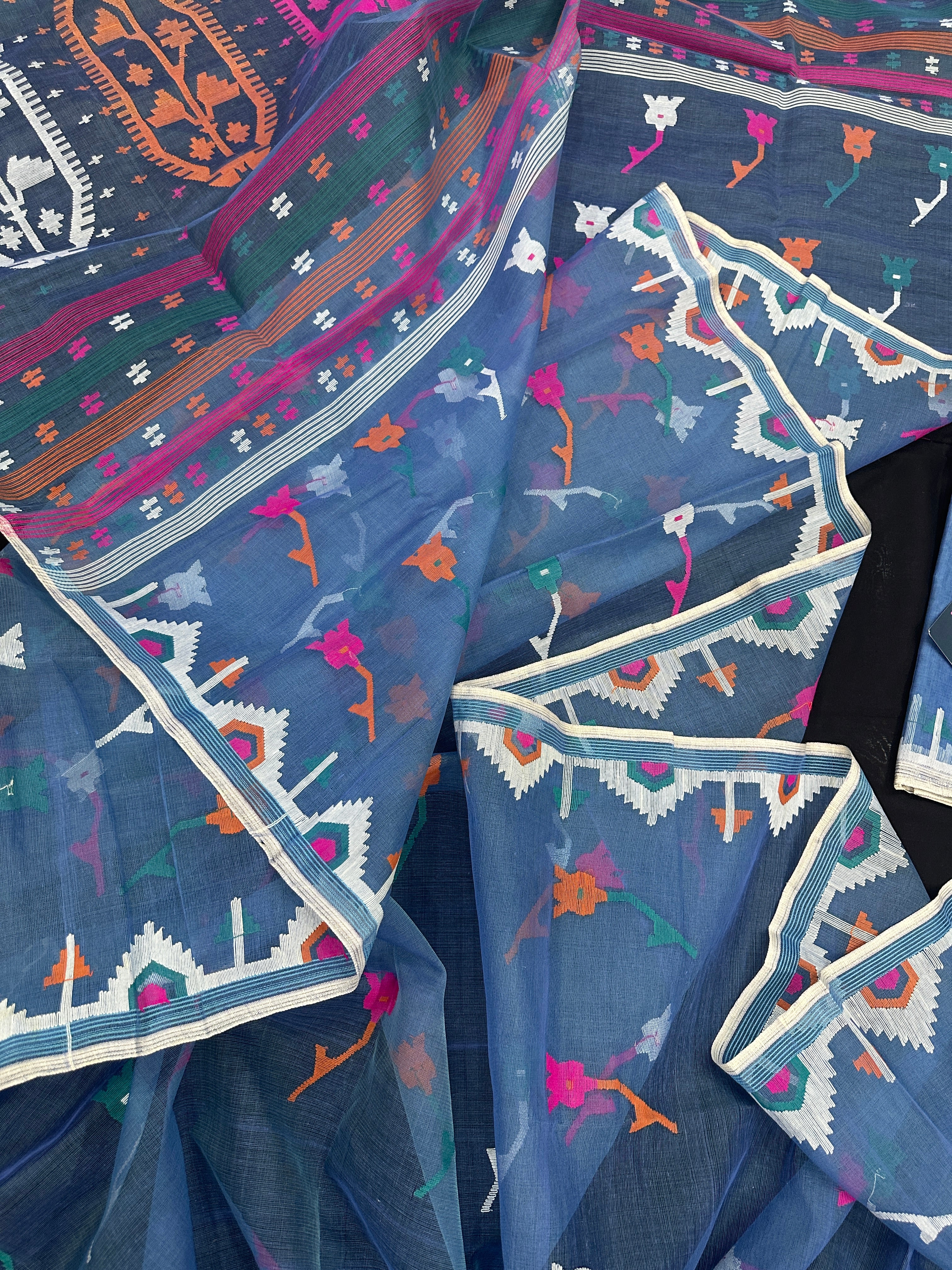 Dusty blue jamdani saree with pink white blue green work and white paar.