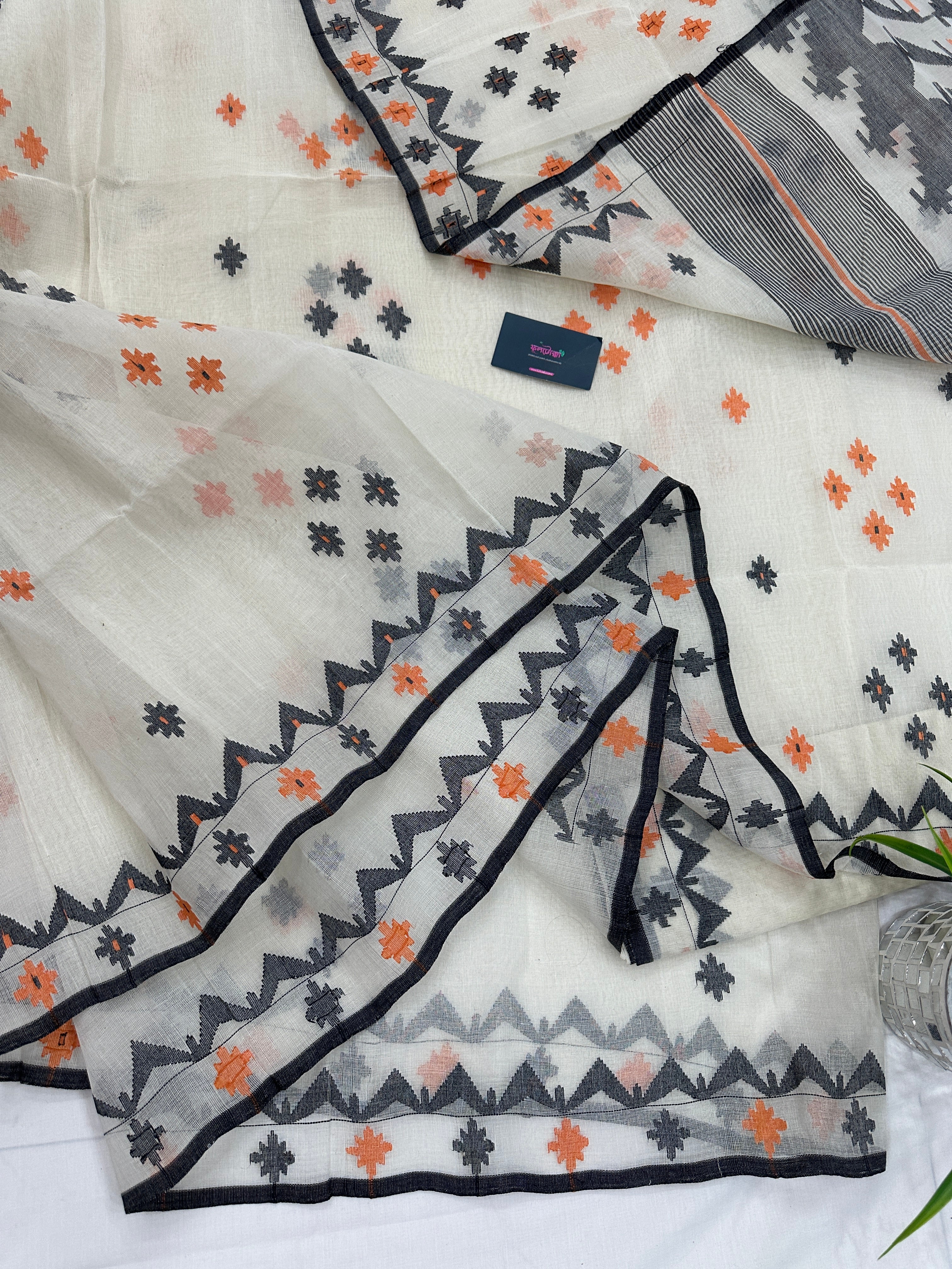 White cotton jamdani saree with orange & black threads work.