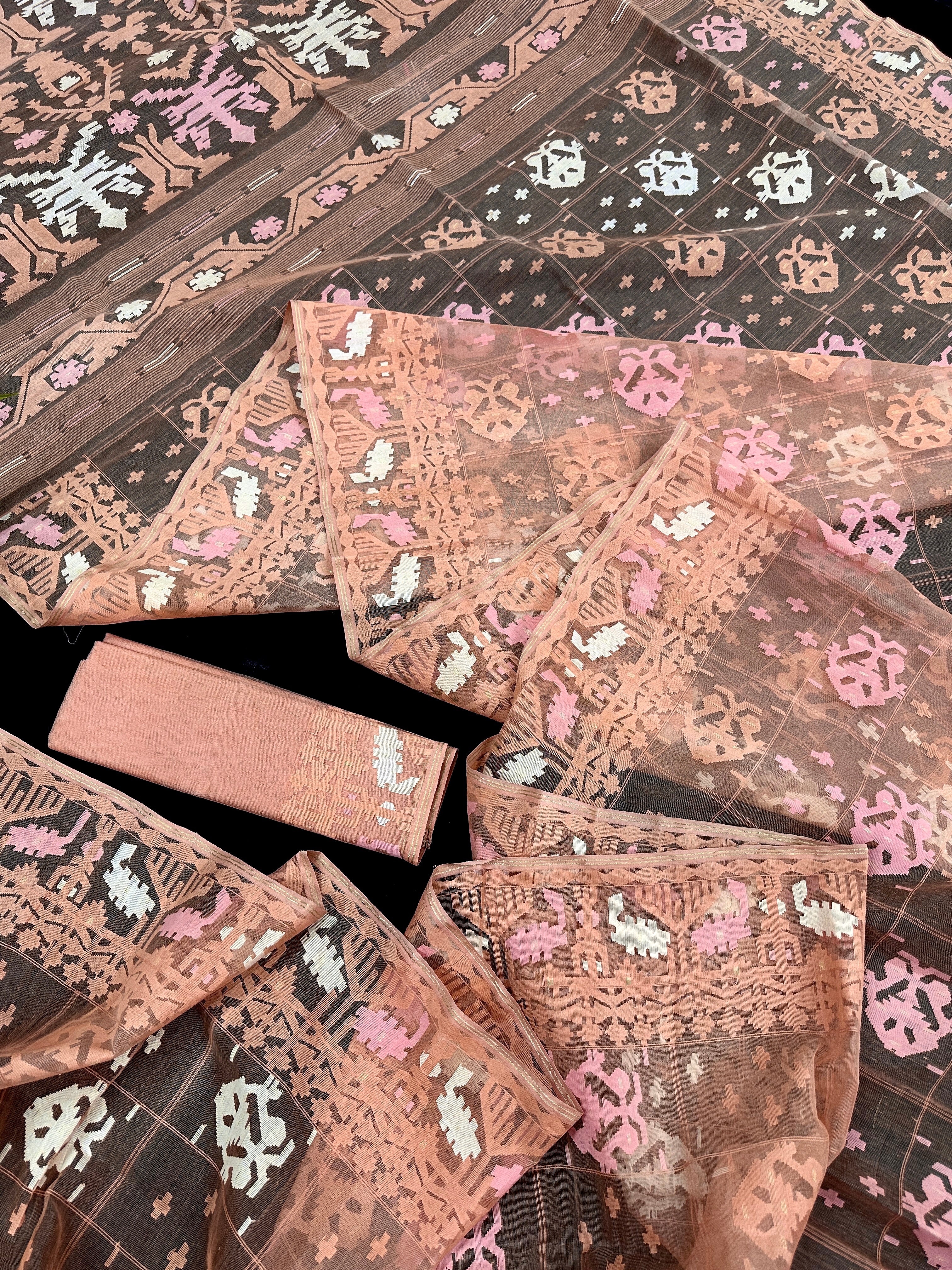 Creamy peach jamdani saree with pink white and peach threads work.