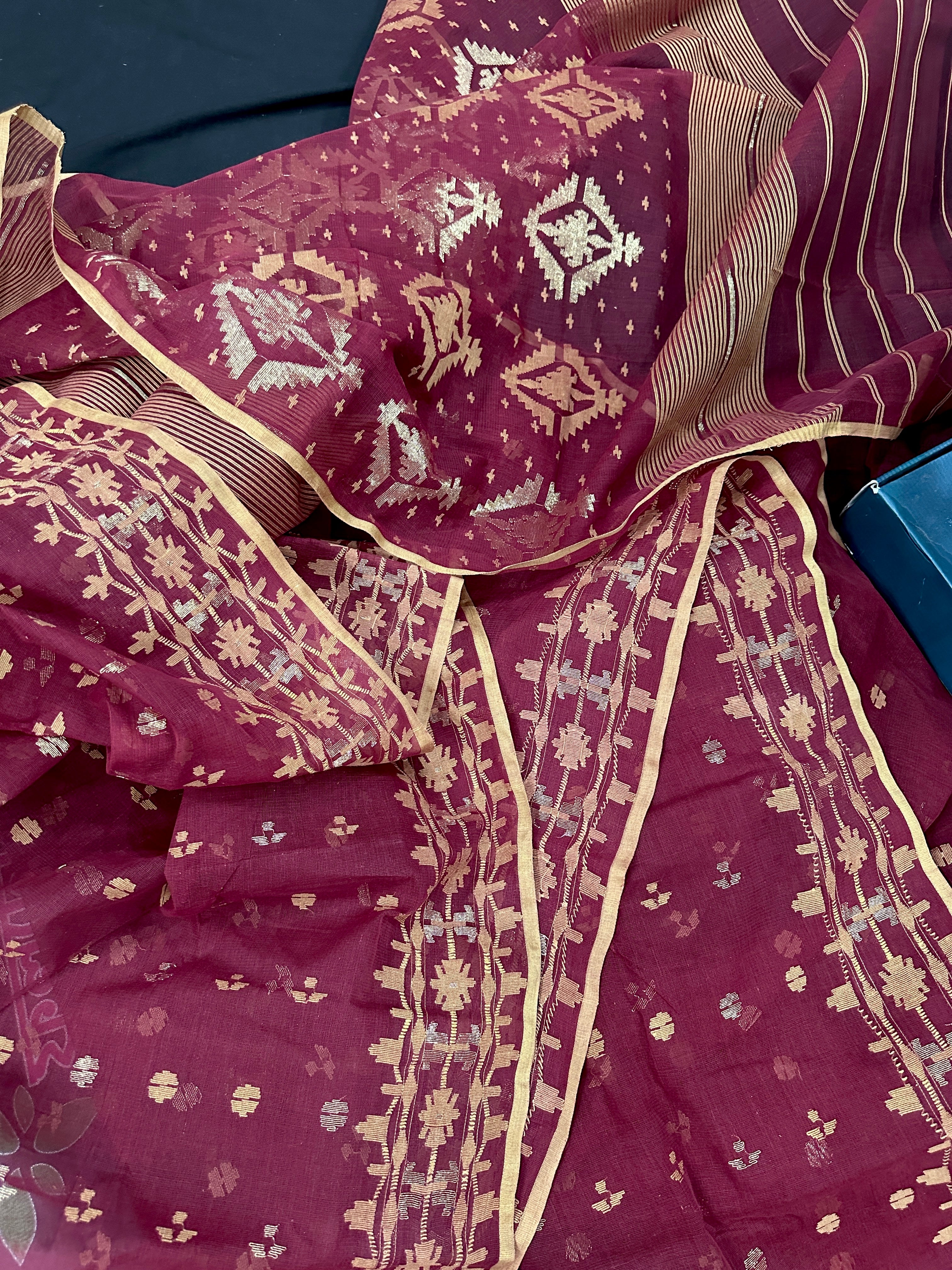Maroon cotton jamdani with yellowish threads work.